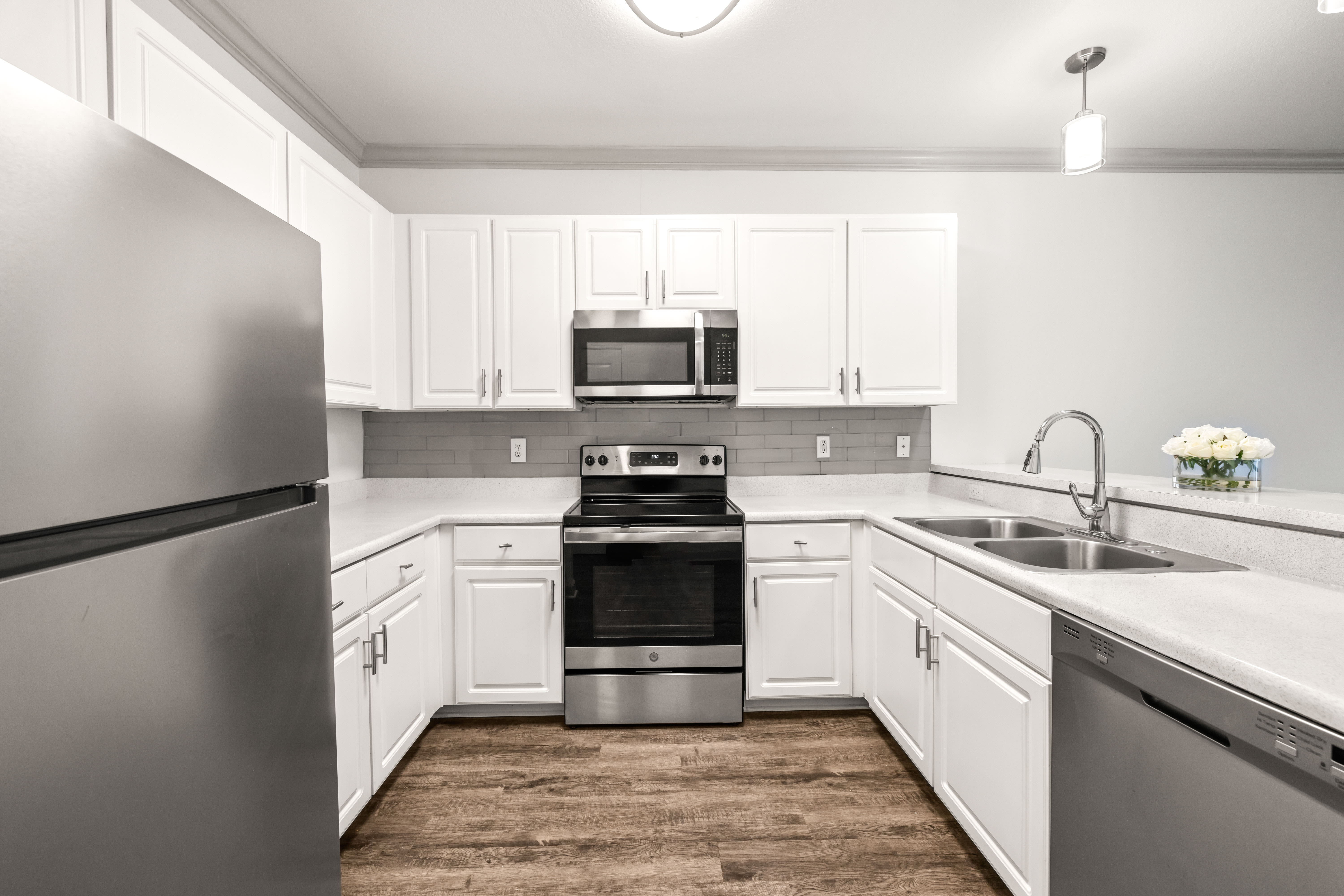 Model apartment's spacious kitchen with ample cupboard space for storage at Olympus Carrington in Pooler, Georgia