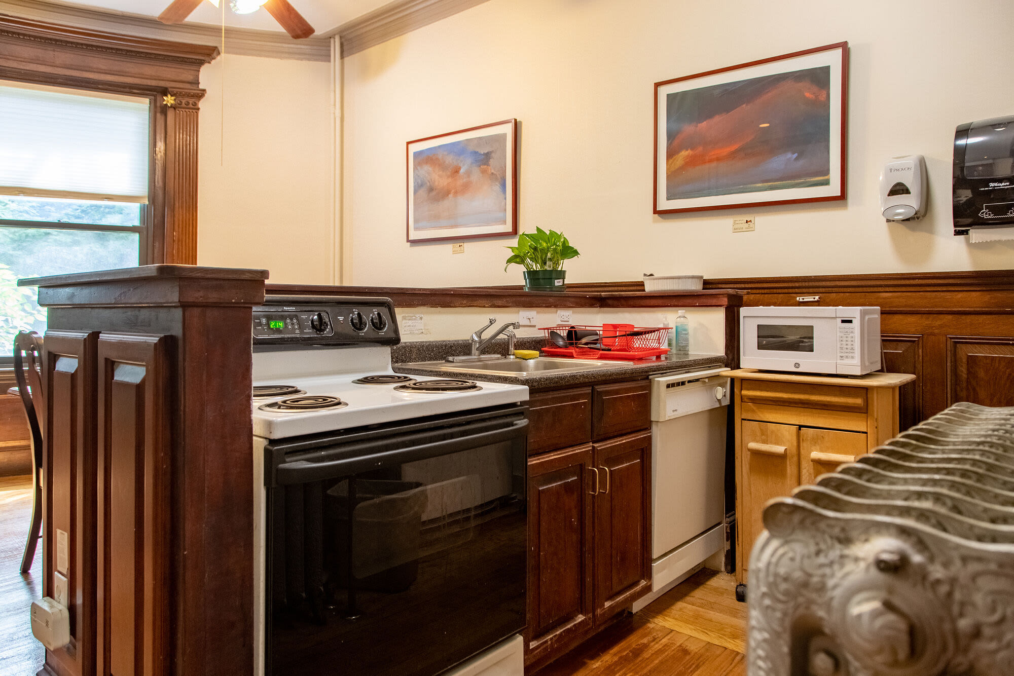 Modern kitchen with wooden cabinets at Hearth Ruth Cowin House in Brookline, Massachusetts