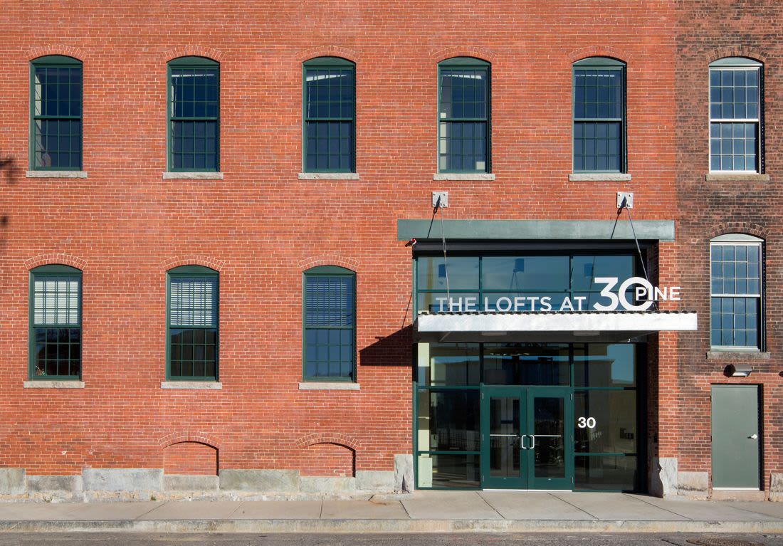 Exterior entry view of the building at The Lofts at 30 Pine in Gardner, Massachusetts