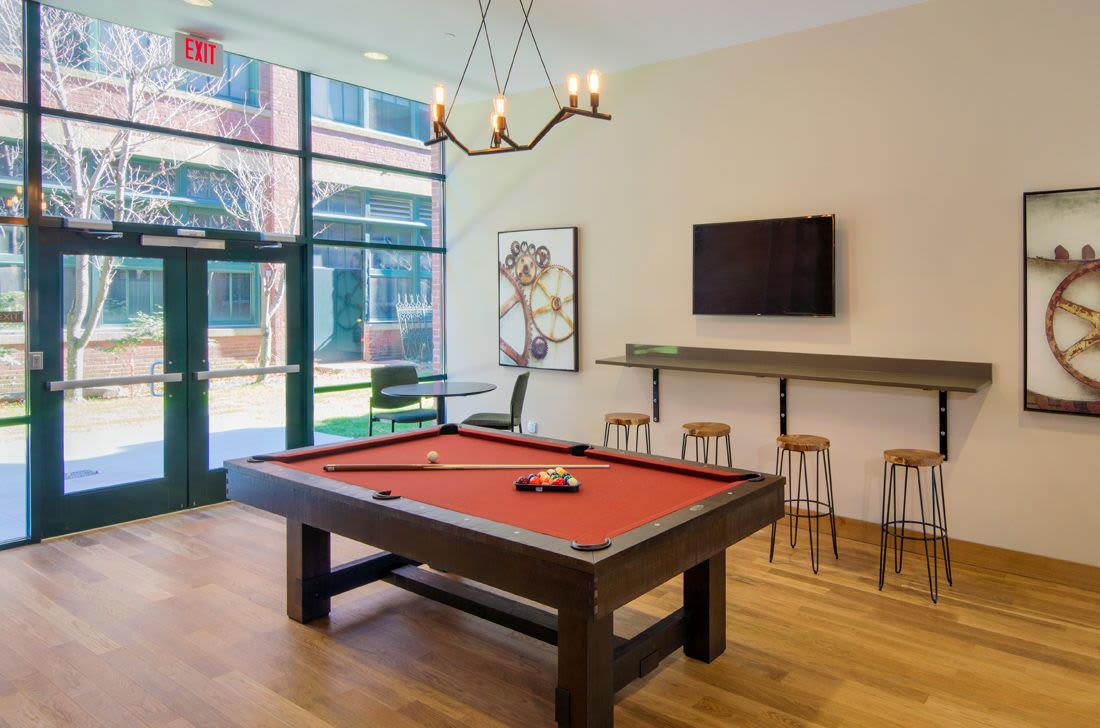 community games room with pool table and stools at The Lofts at 30 Pine in Gardner, Massachusetts