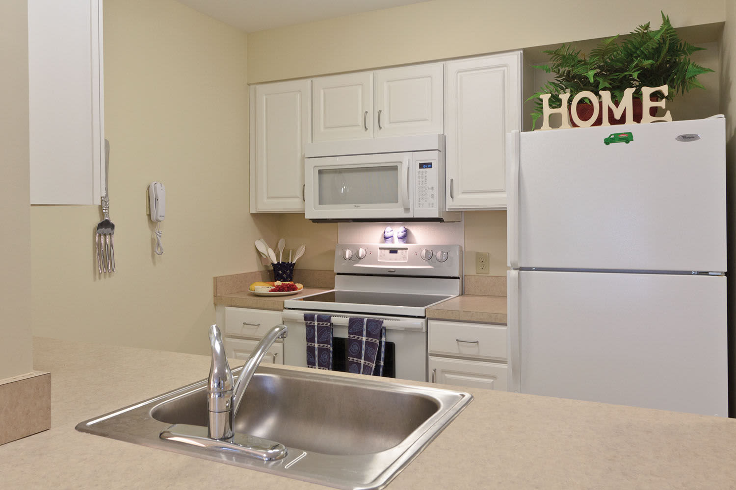Kitchen with white appliances at Little Neck Village in Marion, Massachusetts