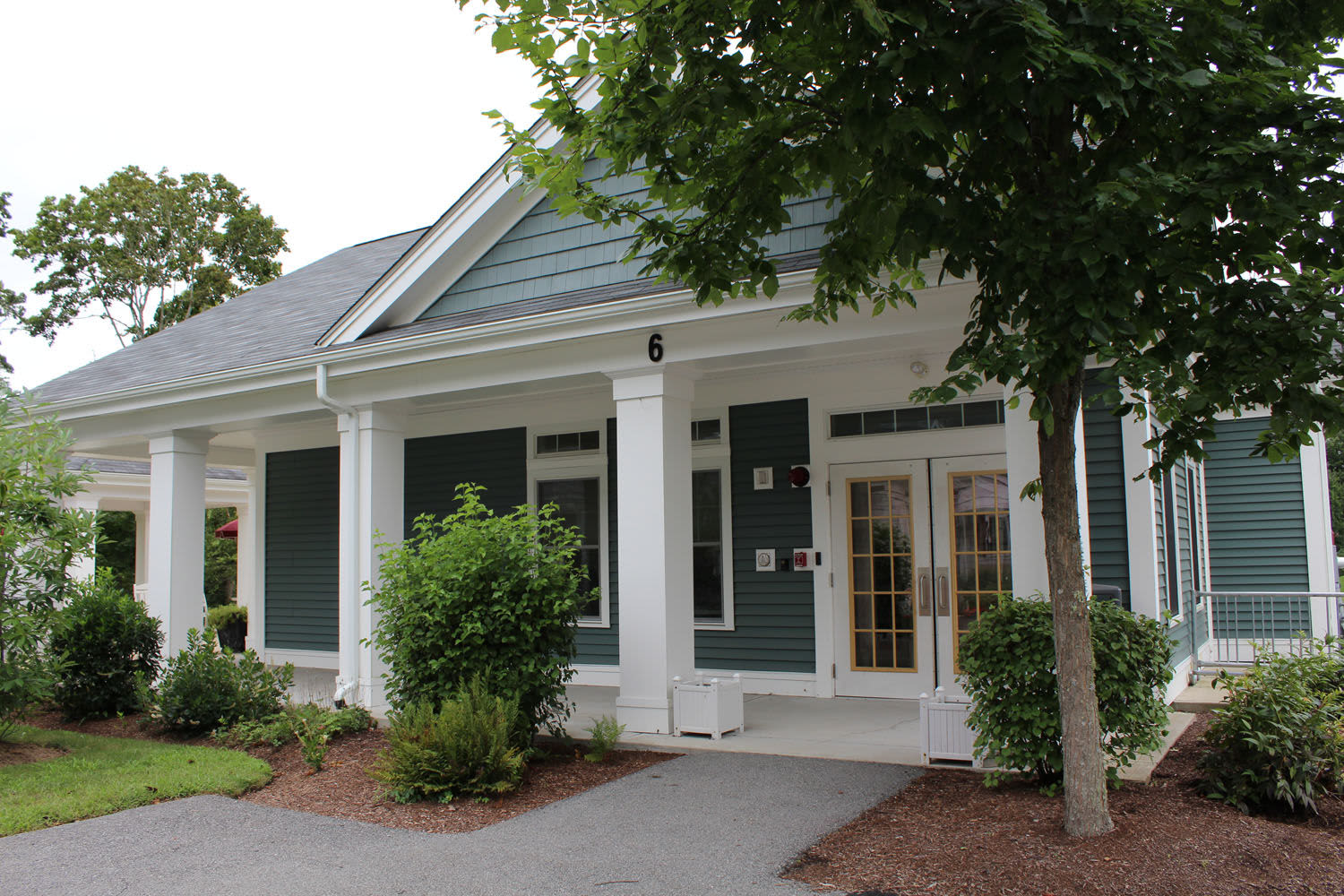 Apartment building with the front yard at Little Neck Village in Marion, Massachusetts