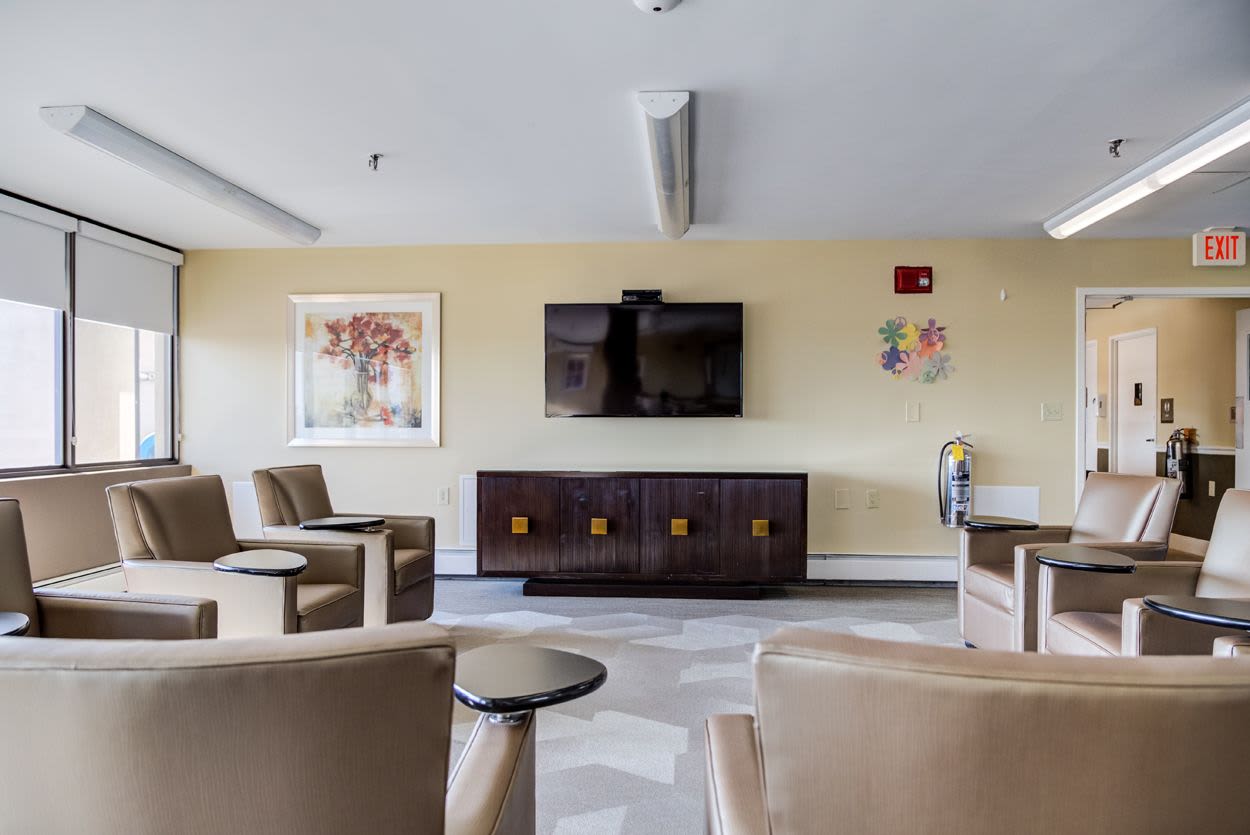 Community lounge area with wall-mounted tv at Melville Towers in New Bedford, Massachusetts