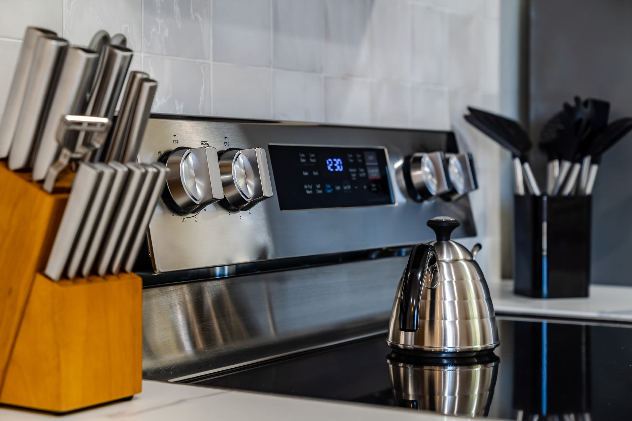 Kitchen with electric range at The Millwright in Cornelius, North Carolina