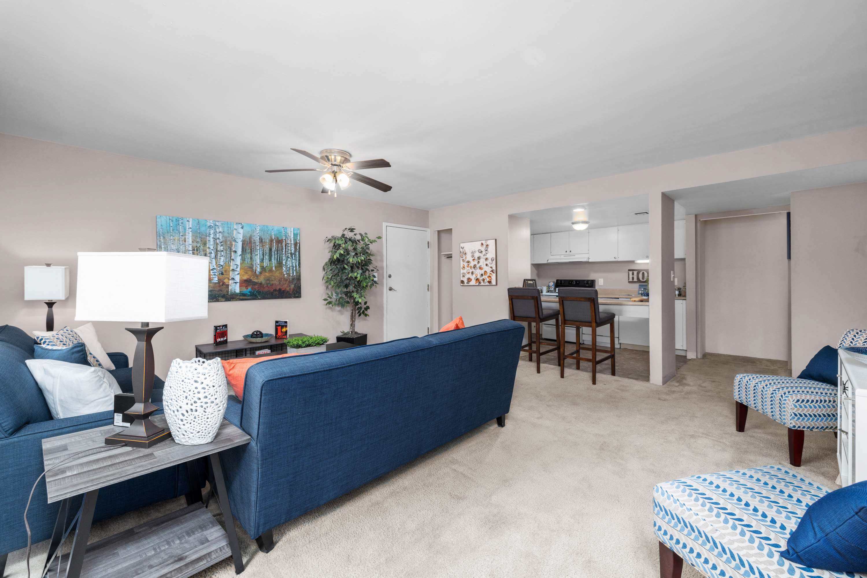 Living room with close access to kitchen and dining area at West End Terrace Apartments in St. Louis, Missouri
