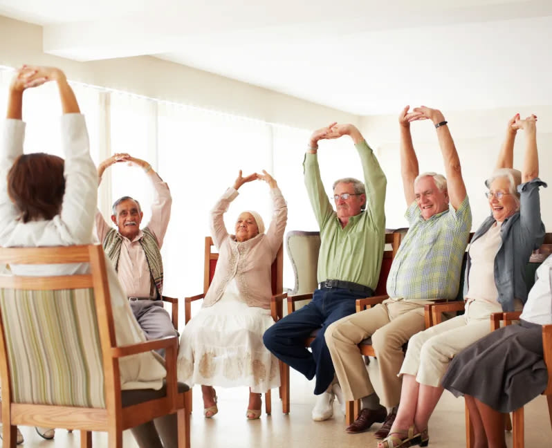 group of senior adults doing arm raises