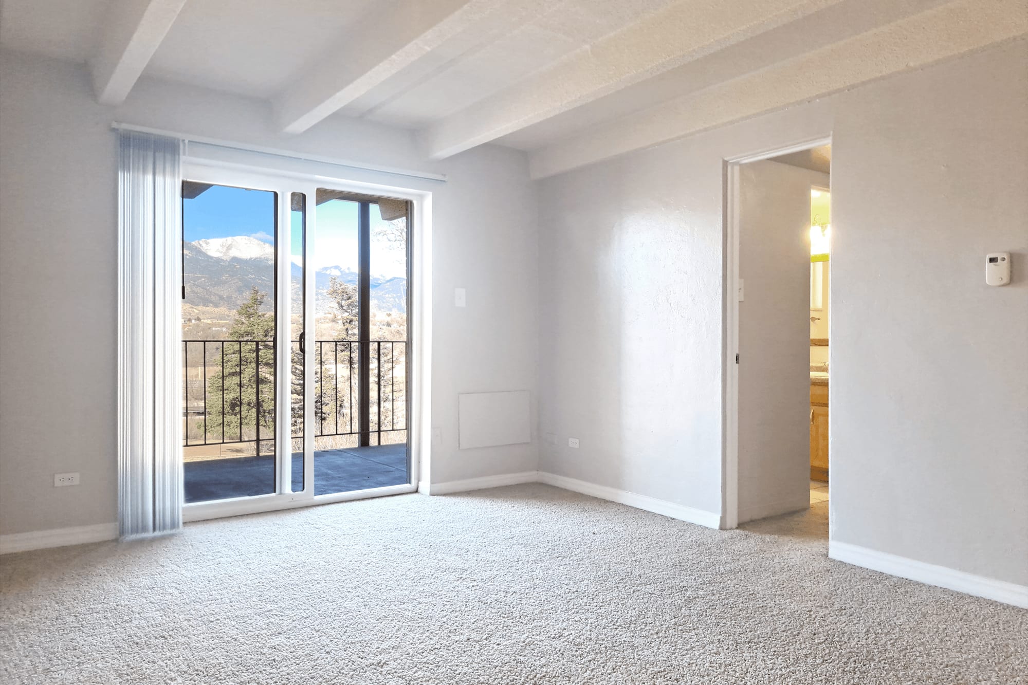 Living space with slider door to balcony at Boulder Crescent in Colorado Springs, Colorado