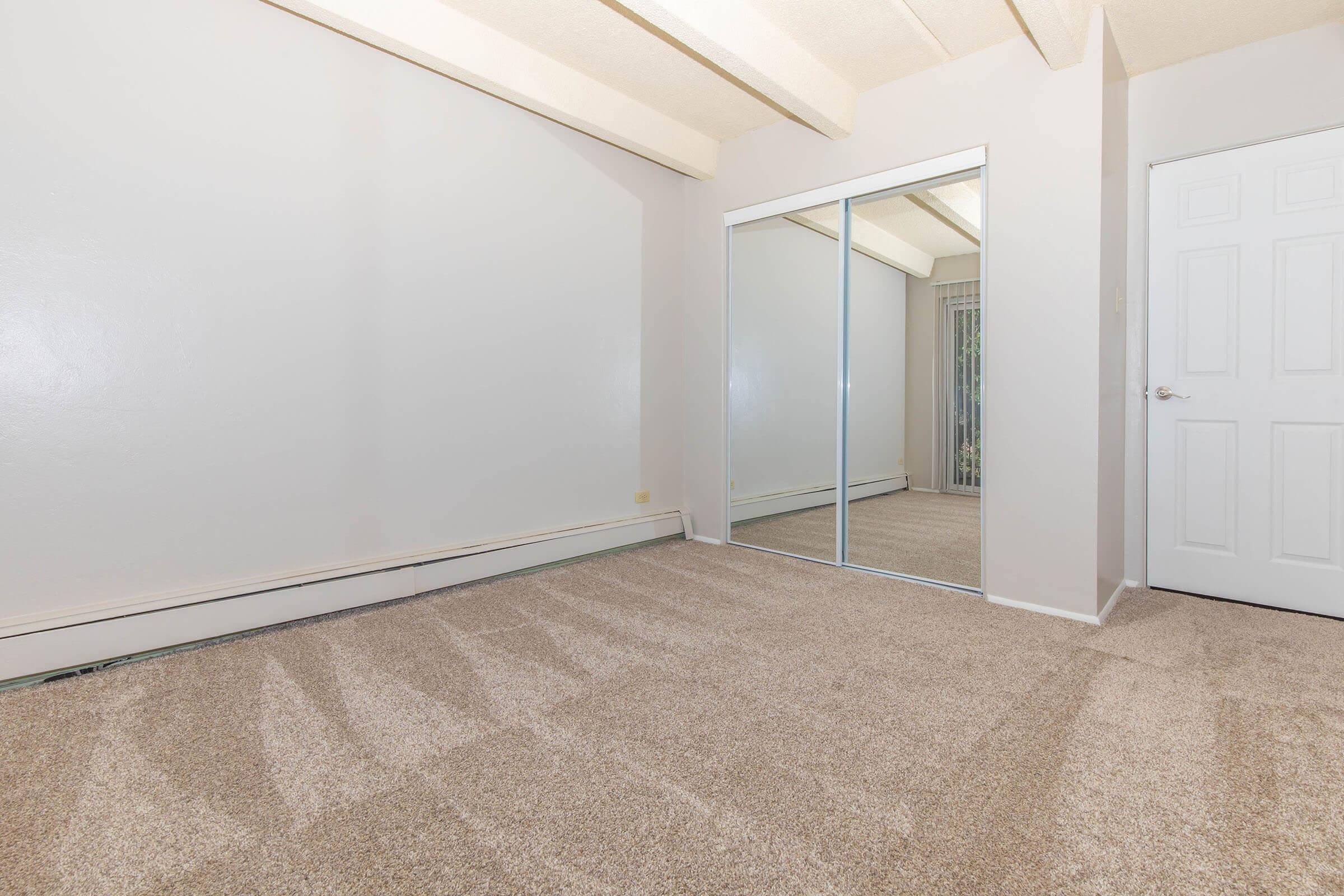 Carpeted bedroom with closet at Boulder Crescent in Colorado Springs, Colorado