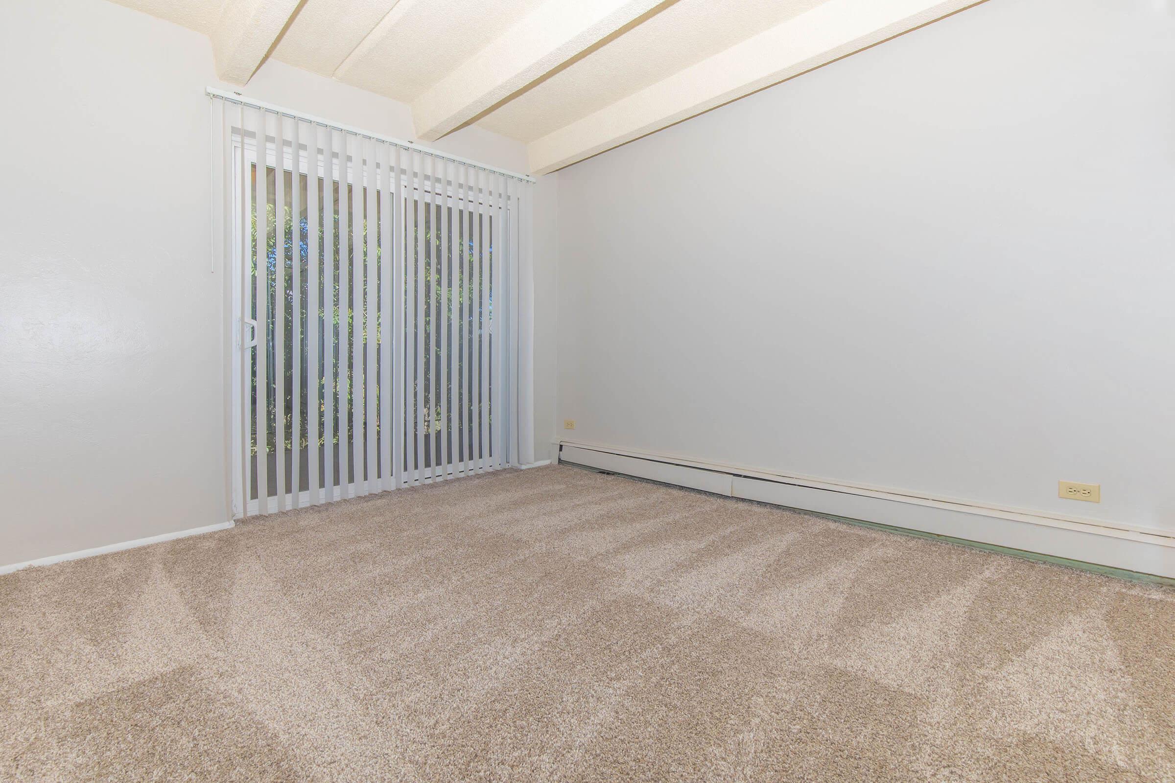 Bedroom with carpet and slider door at Boulder Crescent in Colorado Springs, Colorado