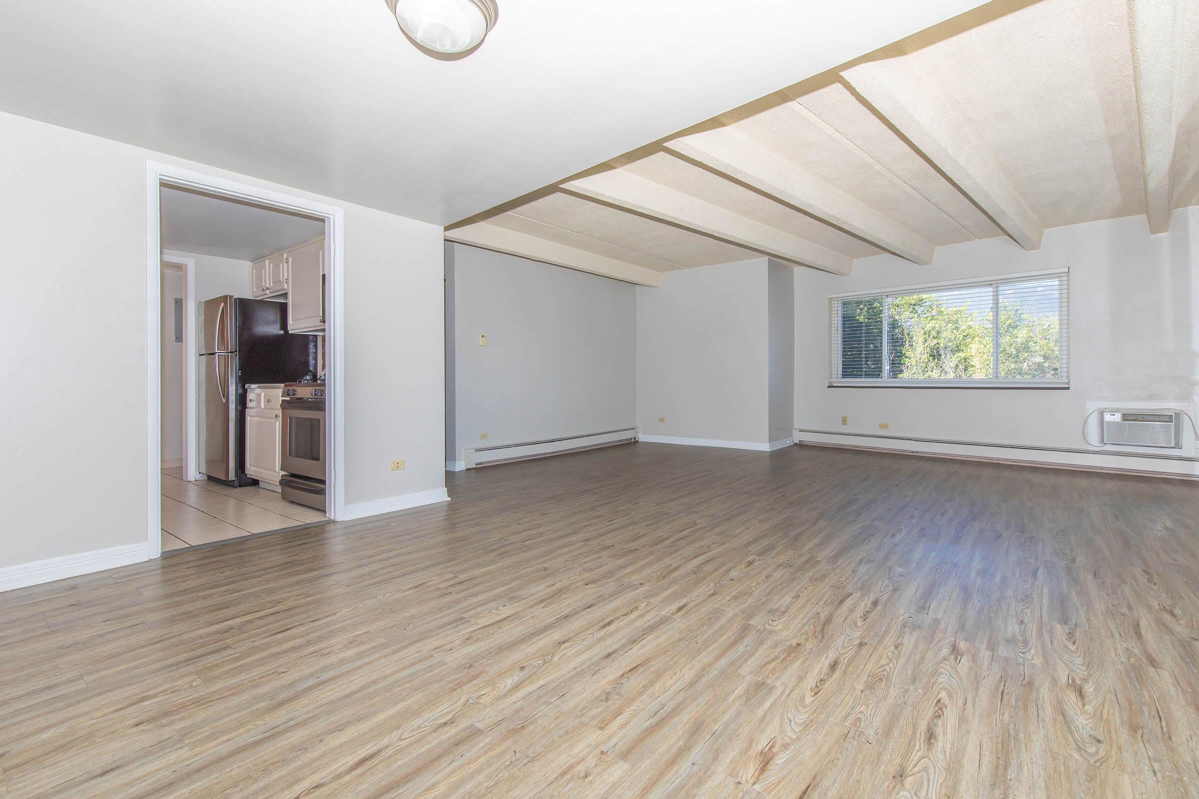 Living room with wood-style floors and ceiling fan at  Boulder Crescent in Colorado Springs,Colorado