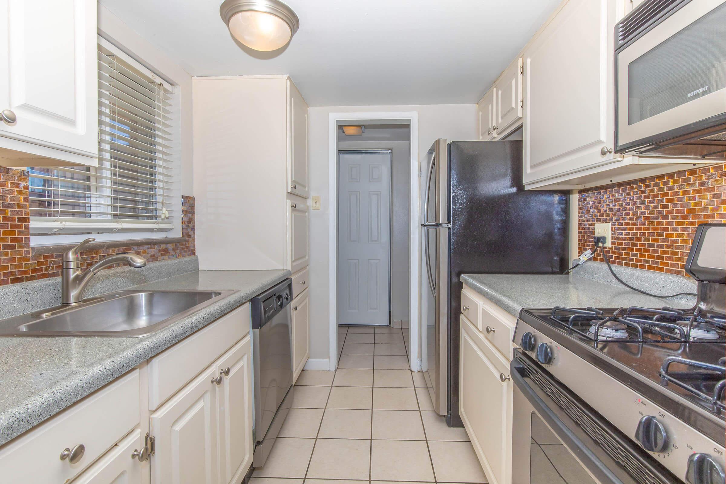 Kitchen with stainless-steel appliances and solid counters at Boulder Crescent in Colorado Springs, Colorado