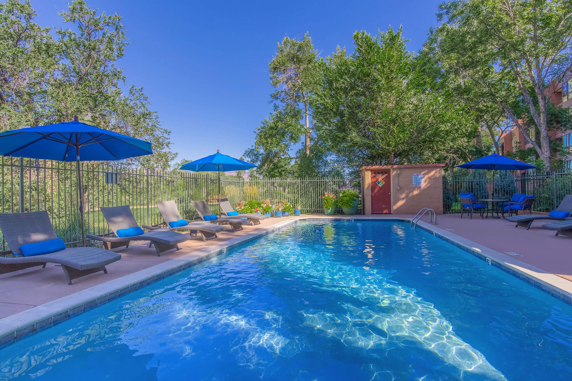 Pool with sun chairs at Boulder Crescent in Colorado Springs, Colorado
