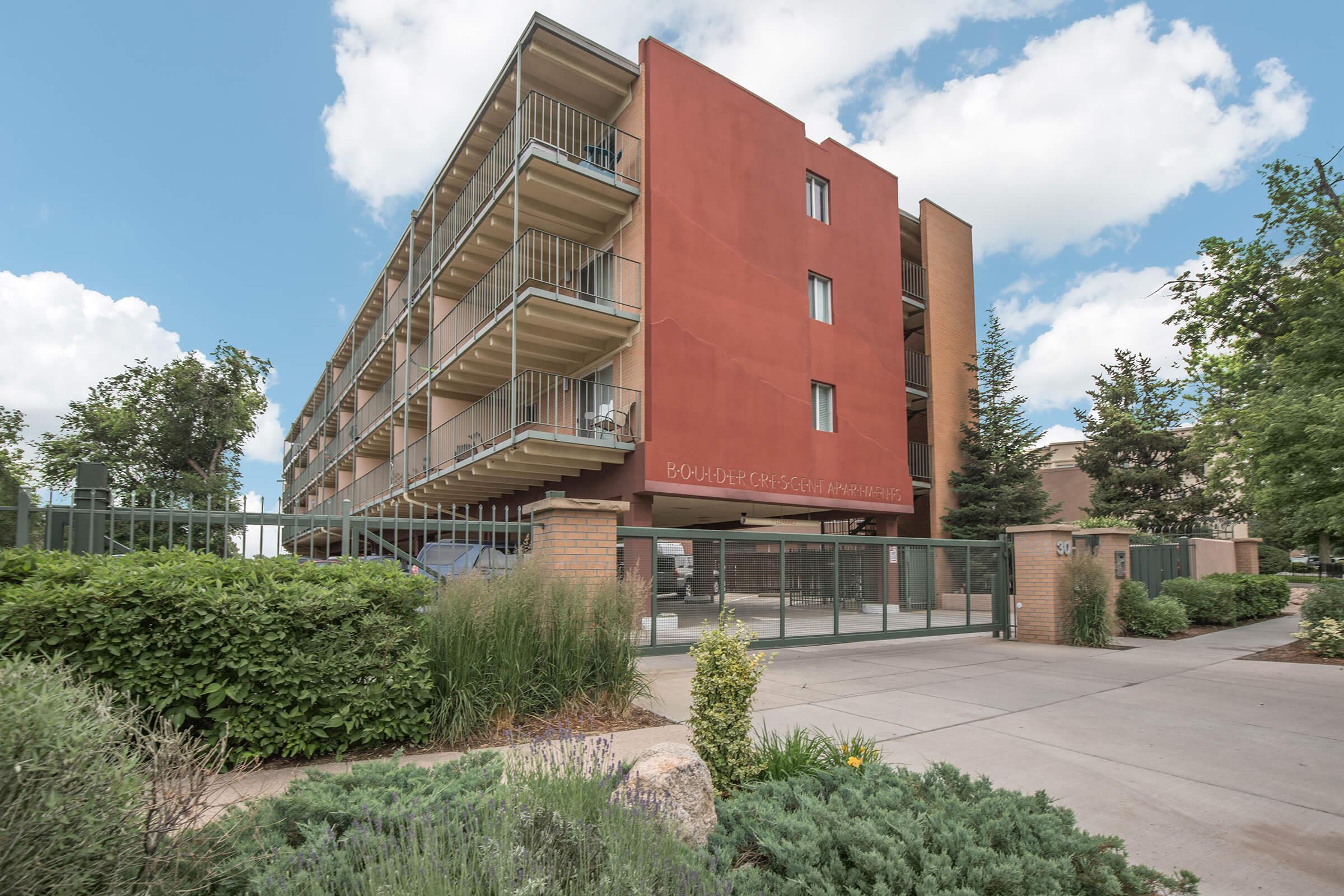 Exterior view of apartments with landscaping at Boulder Crescent in Colorado Springs, Colorado