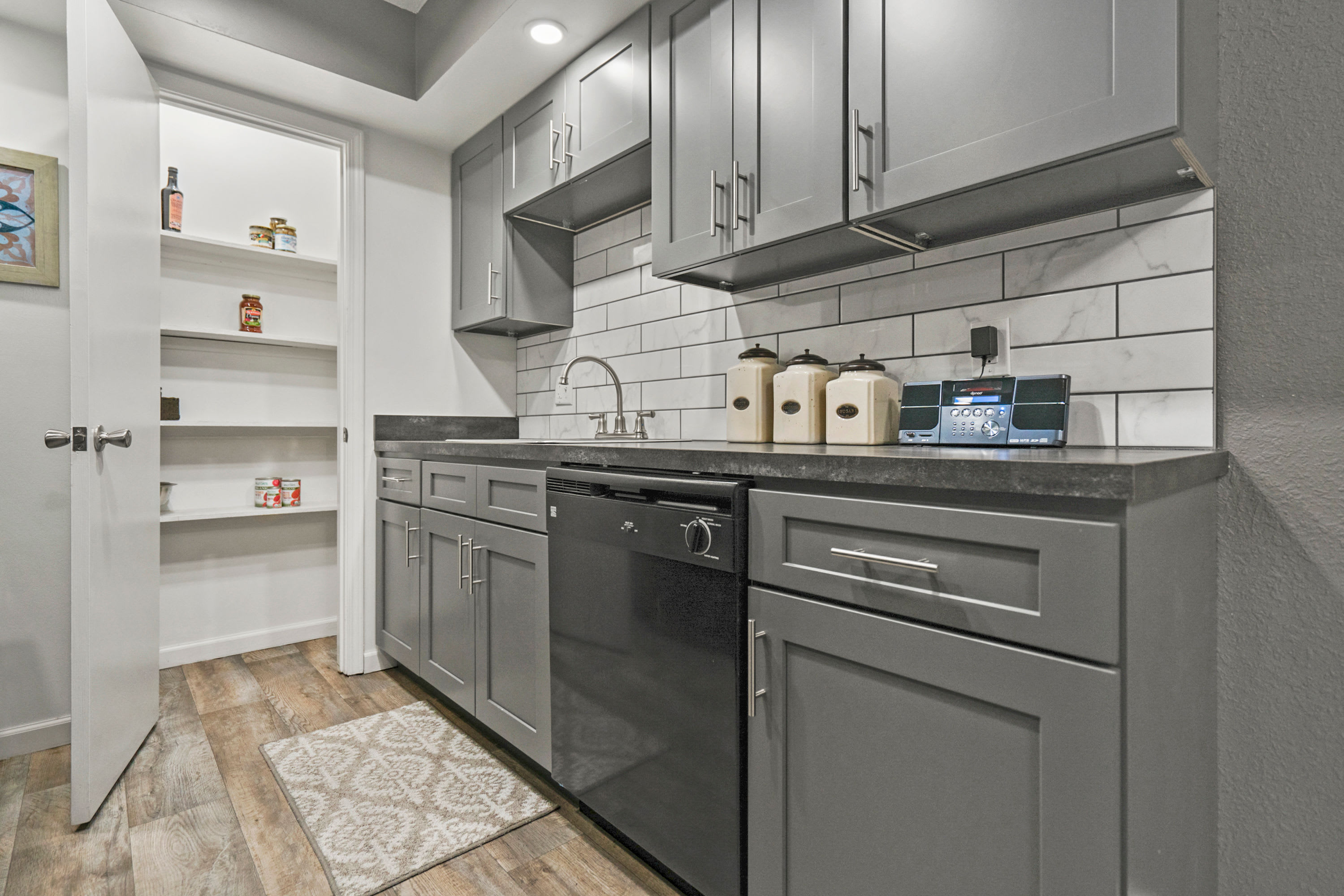 Kitchen with a tile backsplash at Canterbury Green in Fort Wayne, Indiana