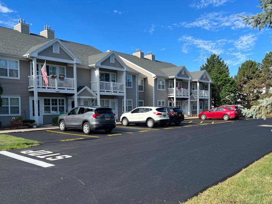 Exterior of an apartment with parking at Summit Knolls Apartments & Townhomes in Webster, New York