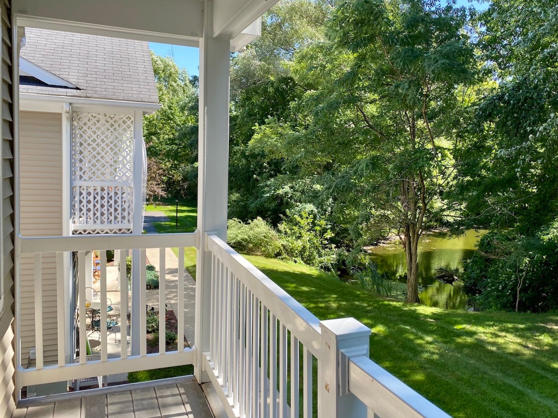 Balcony with green lawn view at Summit Knolls Apartments & Townhomes in Webster, New York