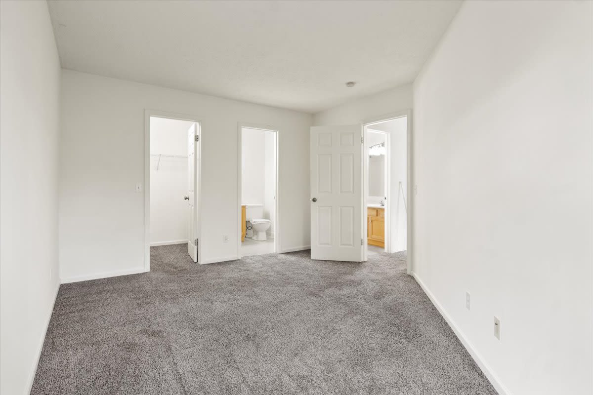 Bedroom with connecting bathroom at Summit Knolls Apartments & Townhomes in Webster, New York