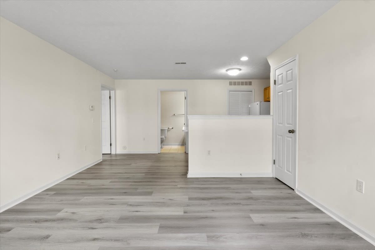 Living area with wood style flooring at Summit Knolls Apartments & Townhomes in Webster, New York