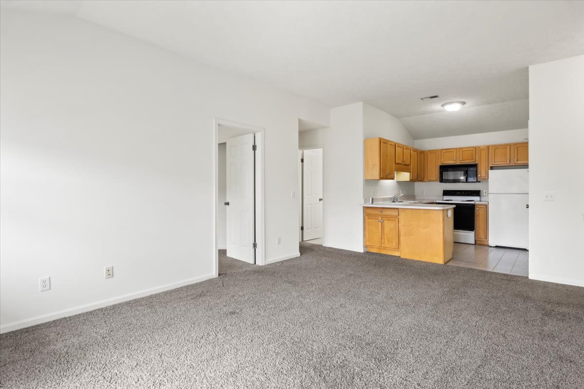 Living room with connecting kitchen at Summit Knolls Apartments & Townhomes in Webster, New York