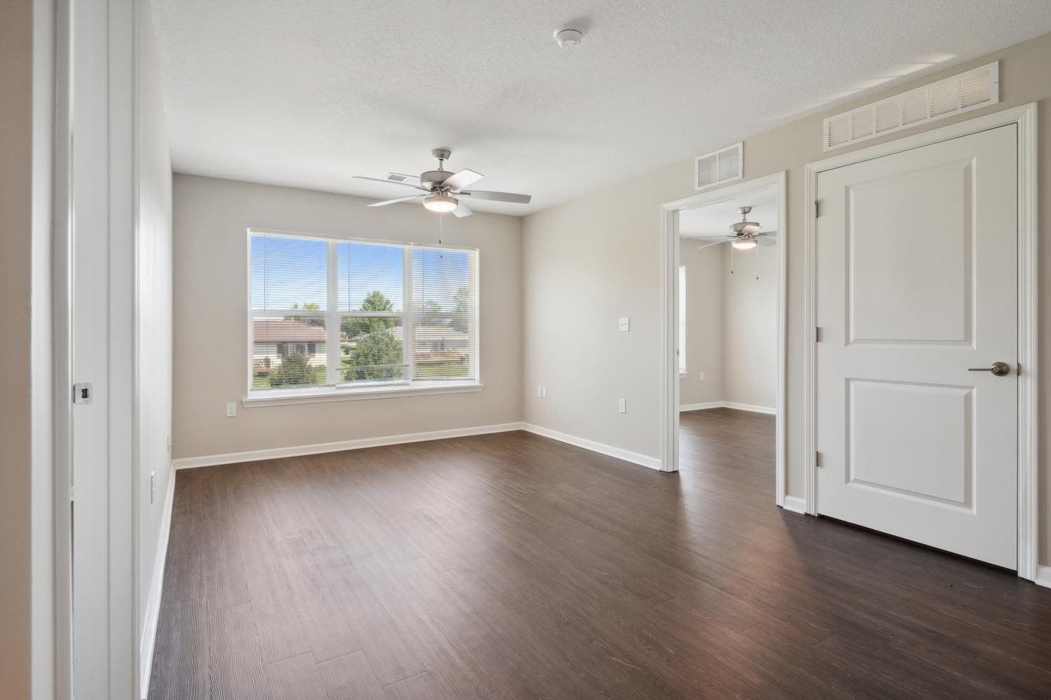 Apartment bedroom with a window at Chandler Pointe in Wilton, Iowa