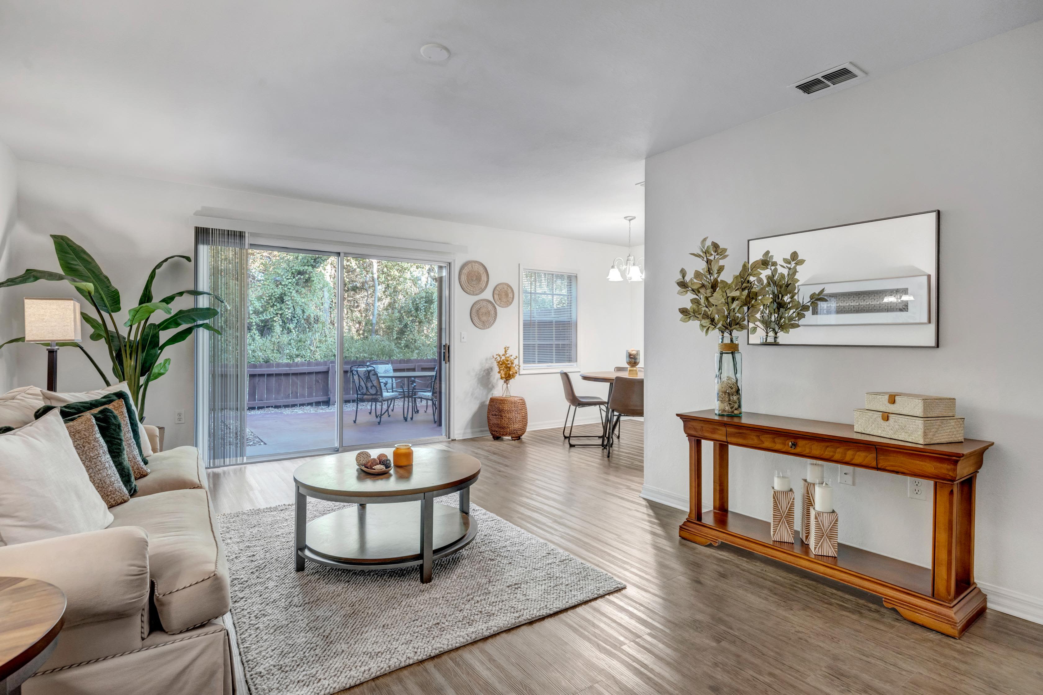 Modern living room with light beige color sofa and coffee table  sofa at Carlton Arms Of Ocala in Ocala, Florida