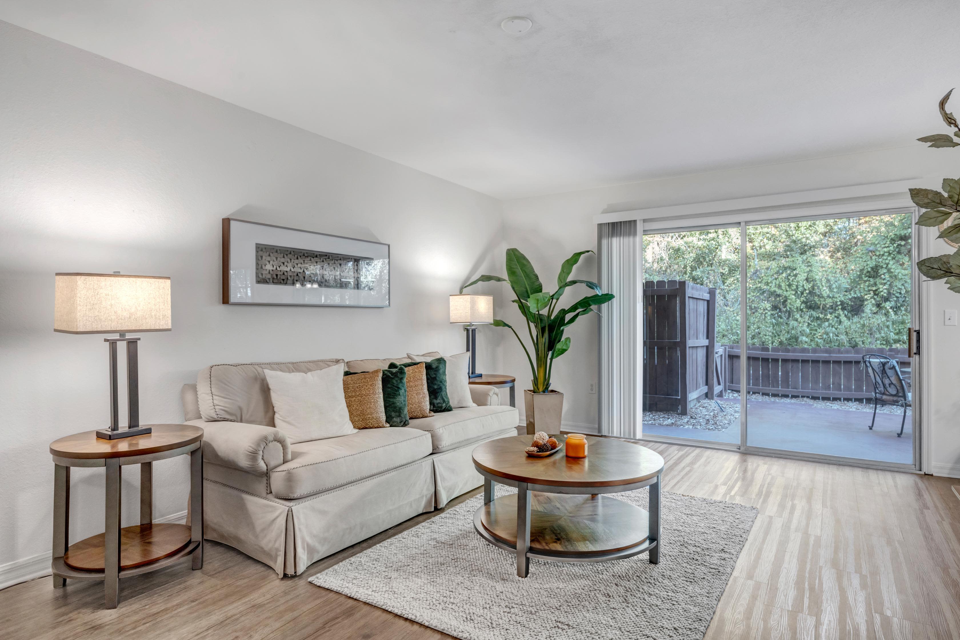 Modern living room with light beige color sofa at Carlton Arms Of Ocala in Ocala, Florida