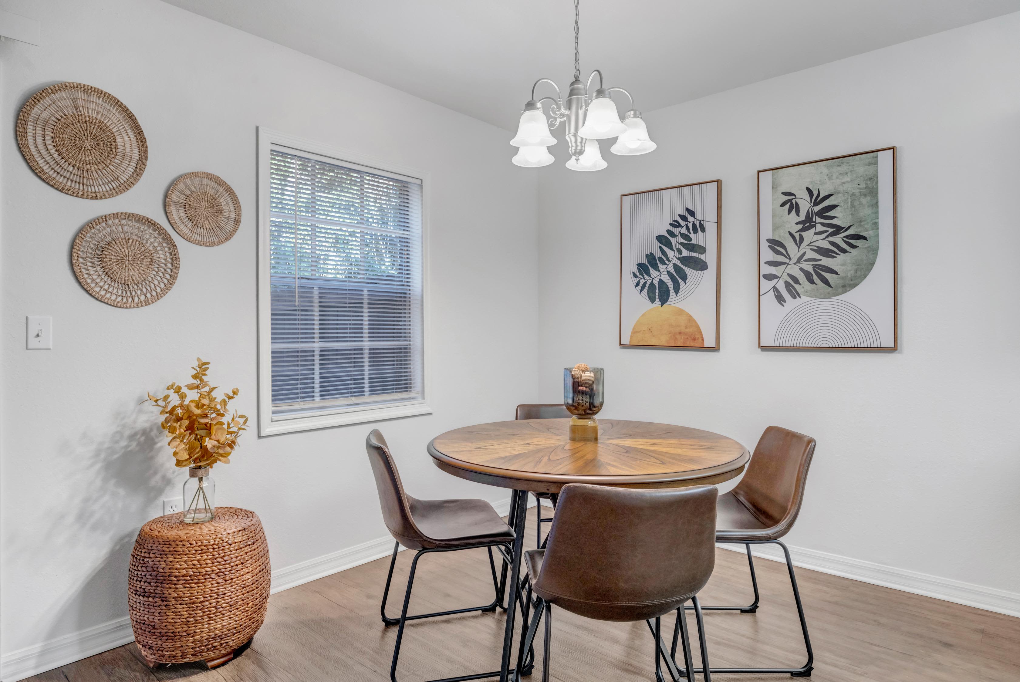Spacious dining room with hanging lamps at Carlton Arms Of Ocala in Ocala, Florida