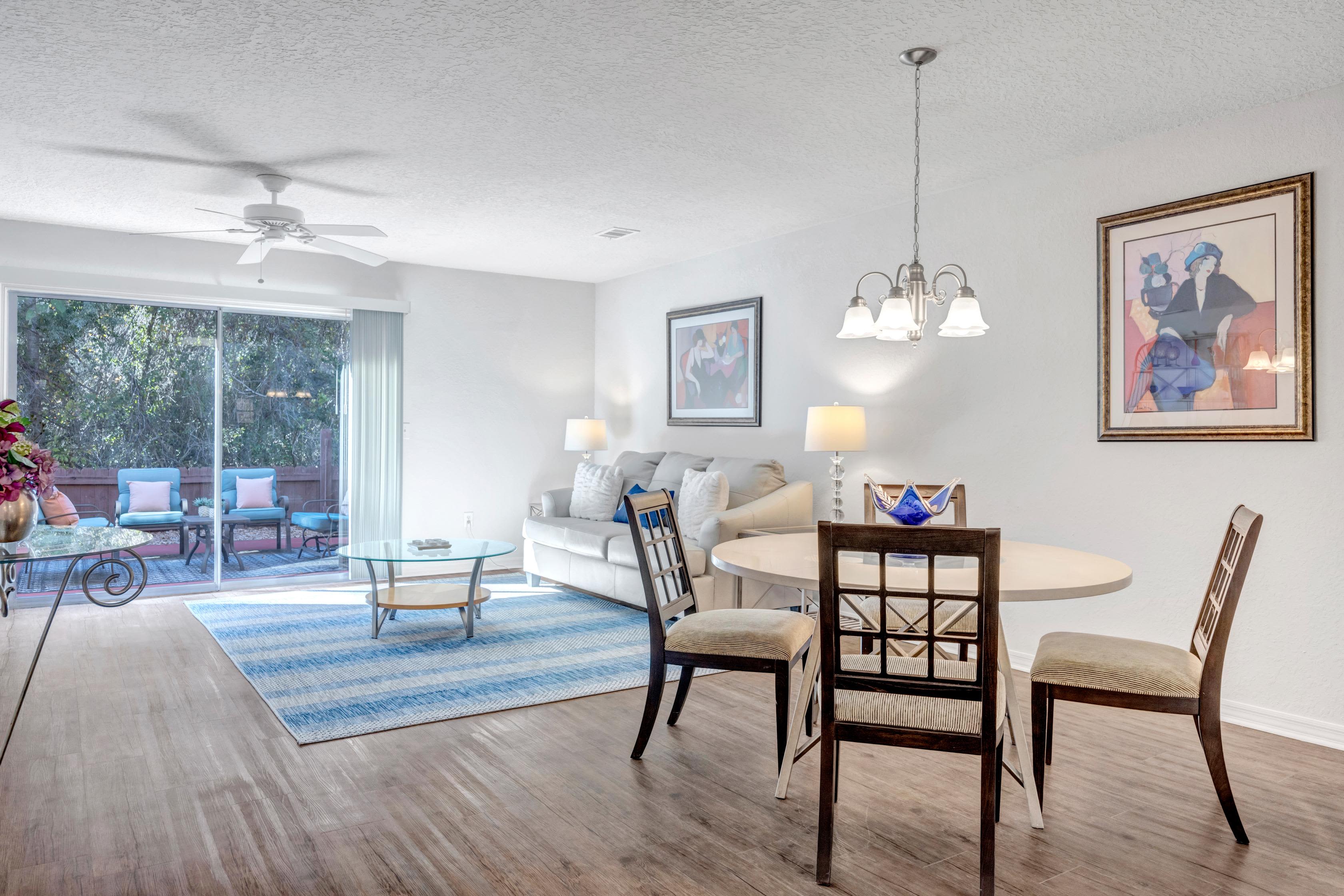 Dining room with hanging lamps and attached living room at Carlton Arms Of Ocala in Ocala, Florida