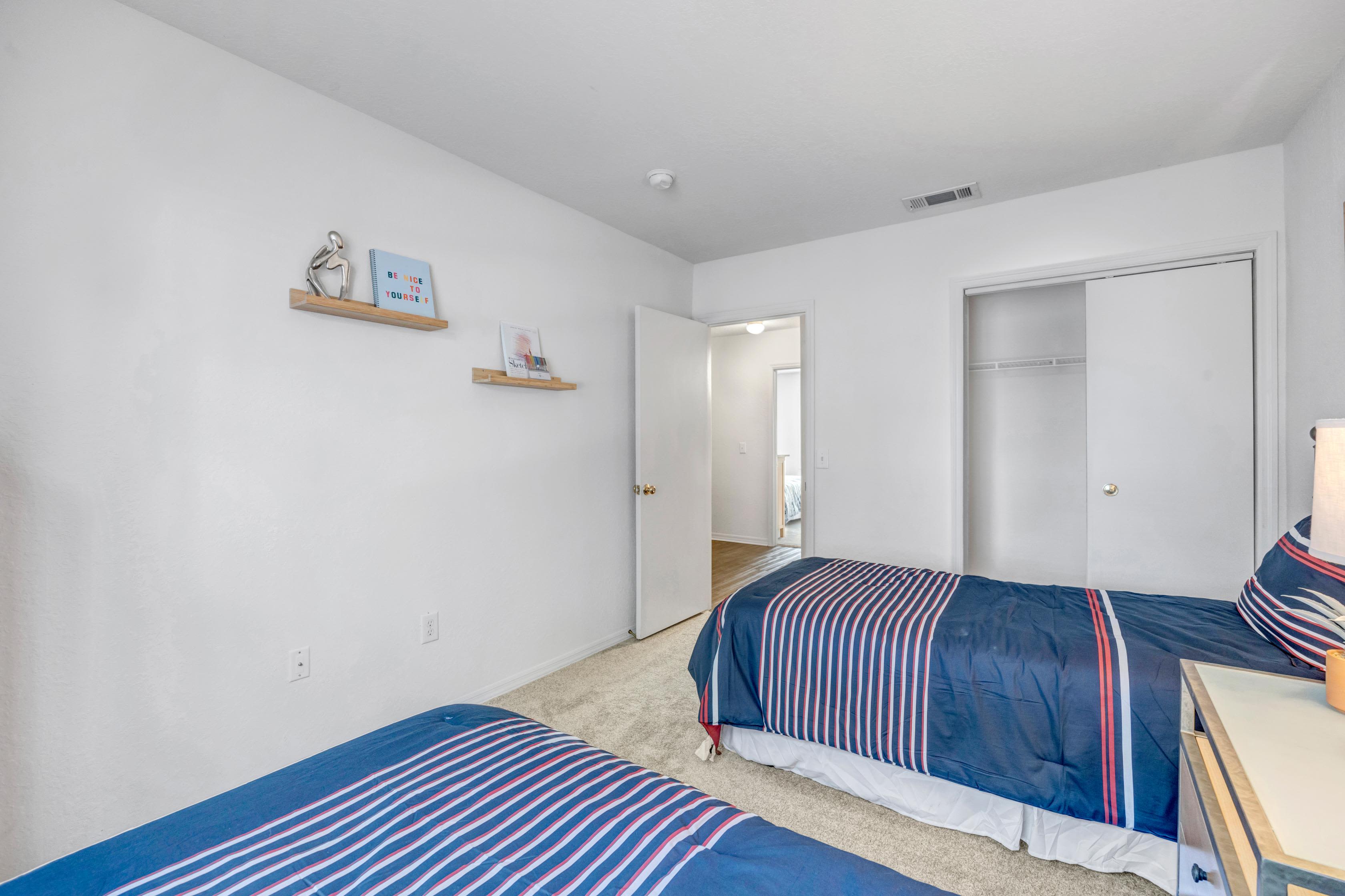 Spacious Modern bedroom with twin beds at Carlton Arms Of Ocala in Ocala, Florida
