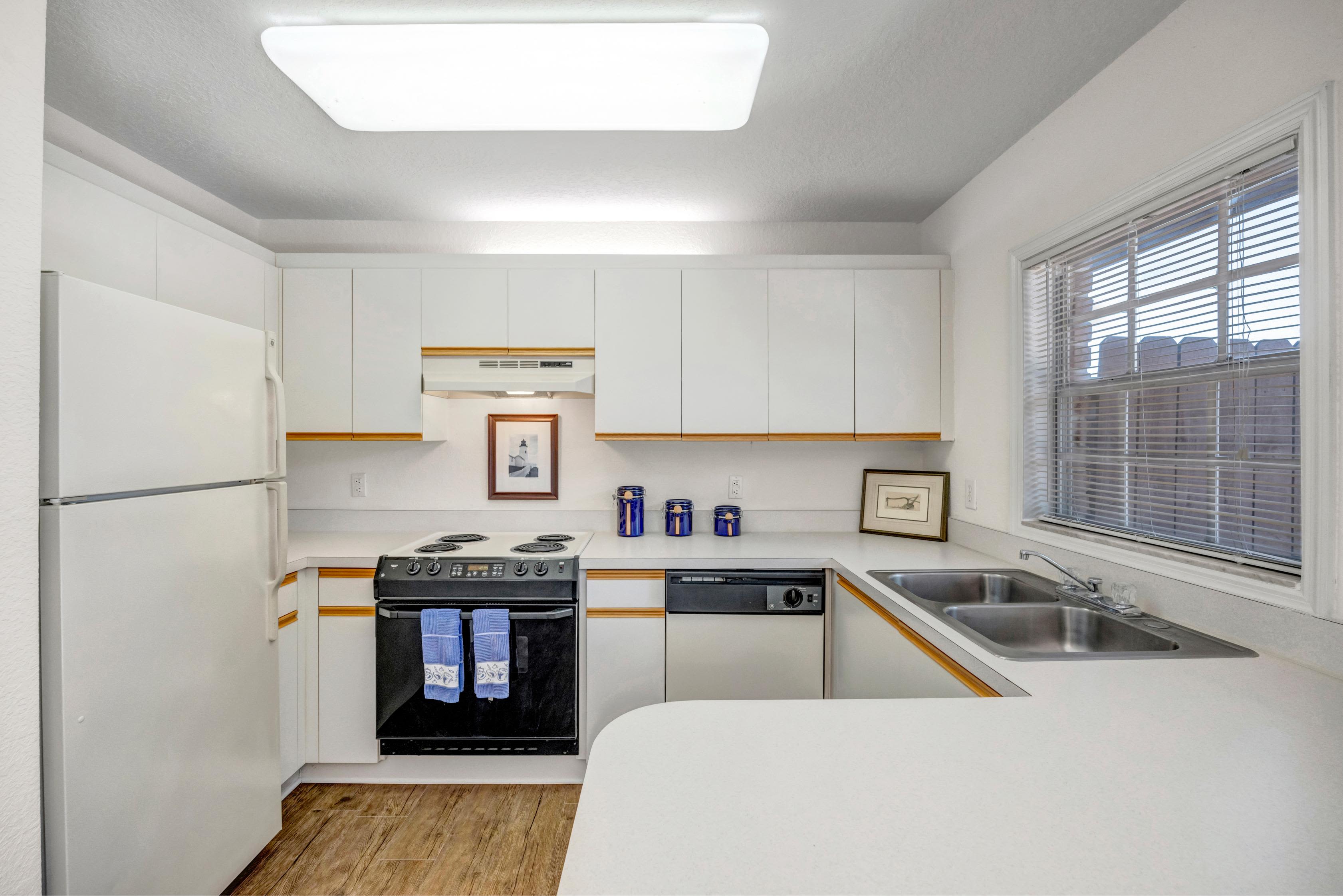 Modern kitchen with white appliances and counter top at Carlton Arms Of Ocala in Ocala, Florida