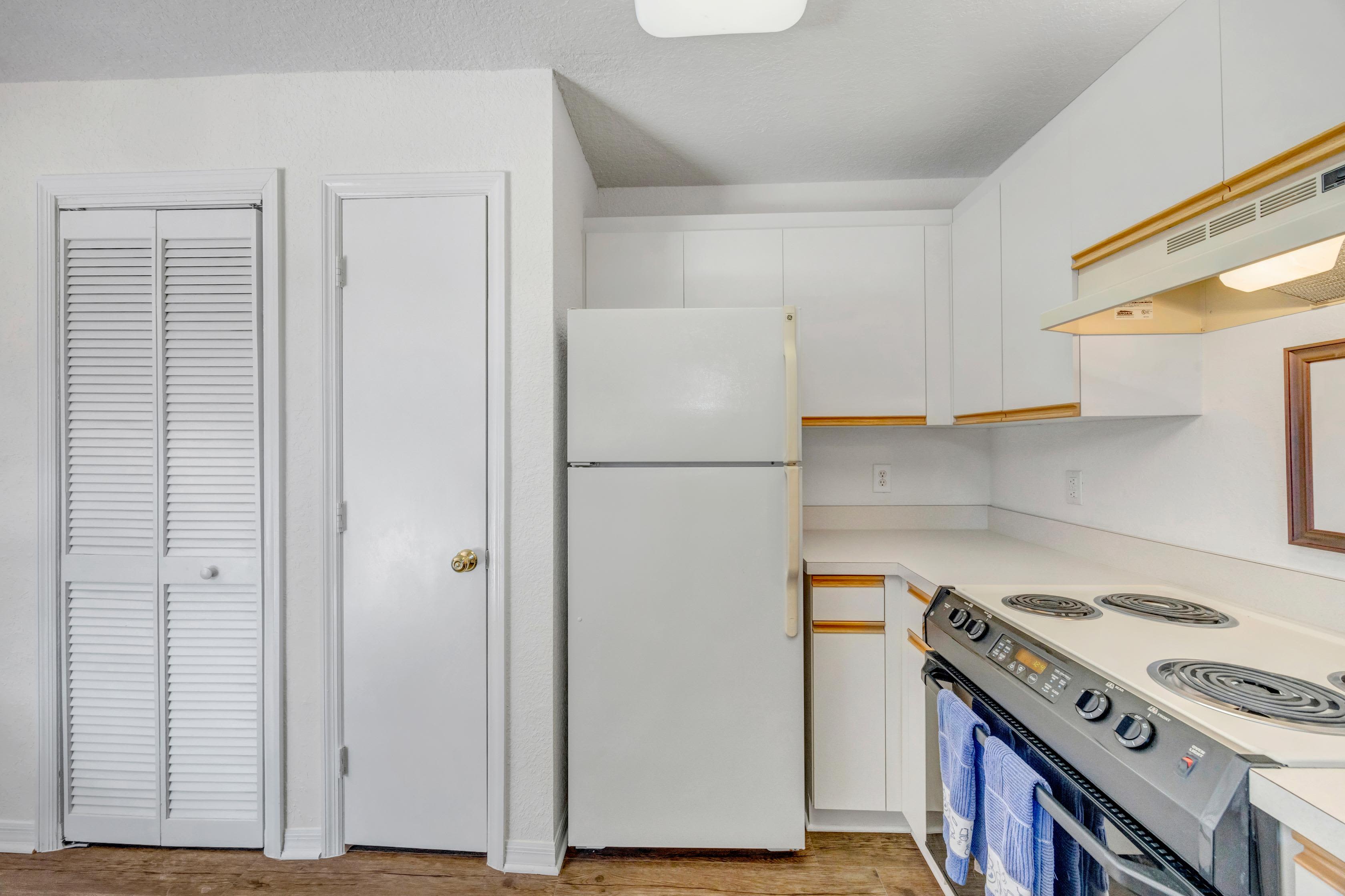 Modern kitchen with white appliances and HVAC at Carlton Arms Of Ocala in Ocala, Florida