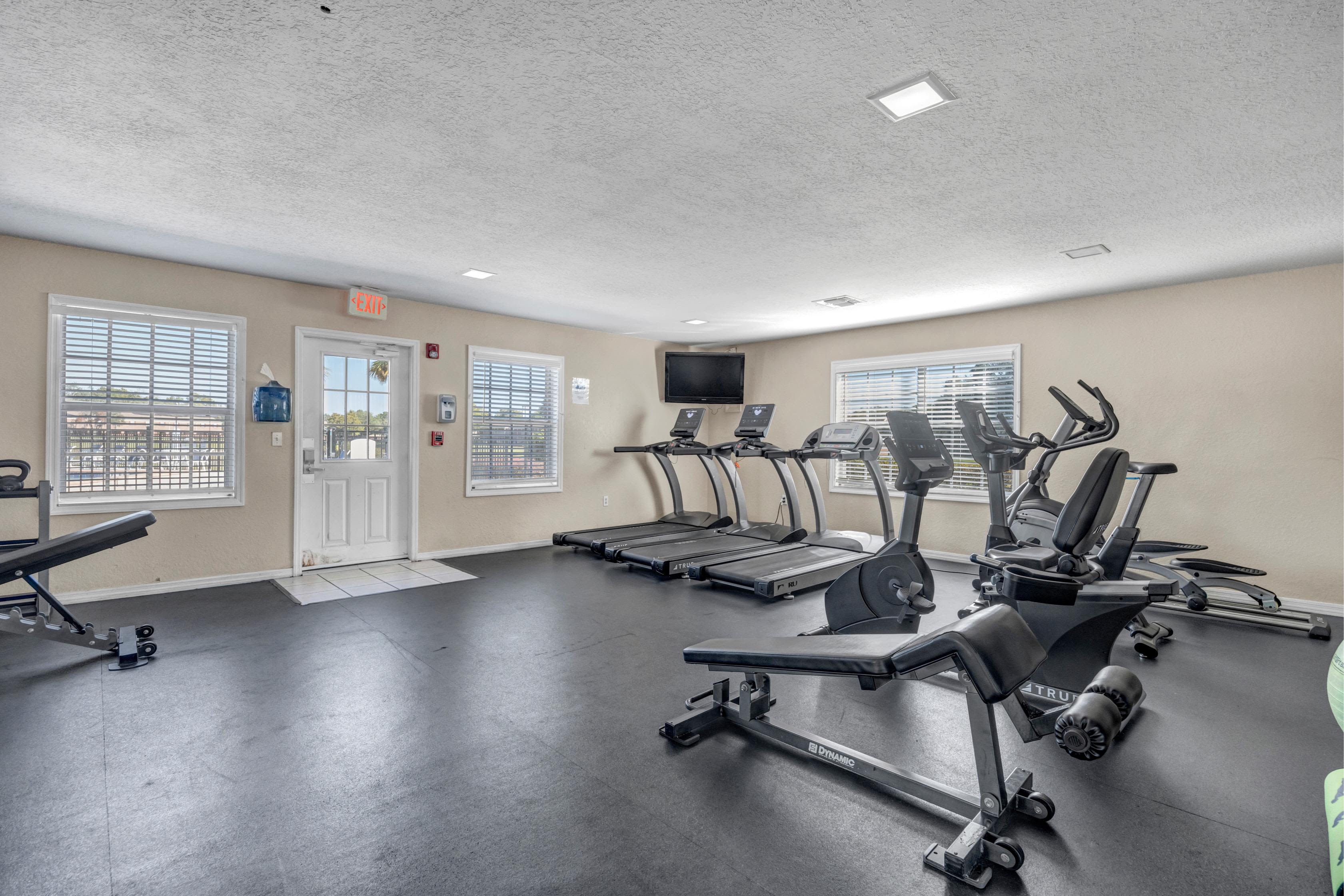 Community fitness center with weight lifting and  gym equipment's  at Carlton Arms Of Ocala in Ocala, Florida