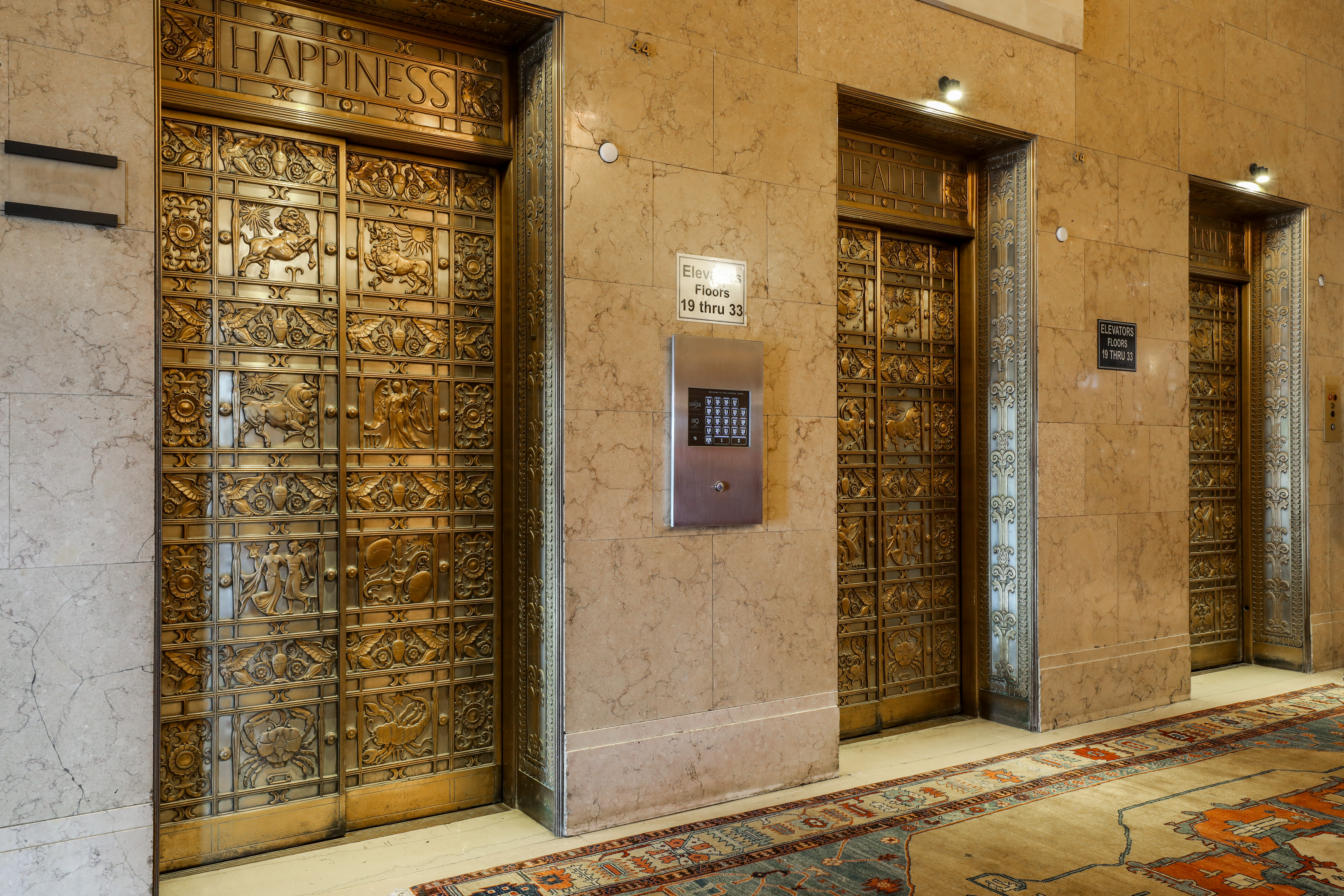 Elegant elevator doors with intricate designs and luxurious carpeting at LeVeque Tower in Columbus, Ohio
