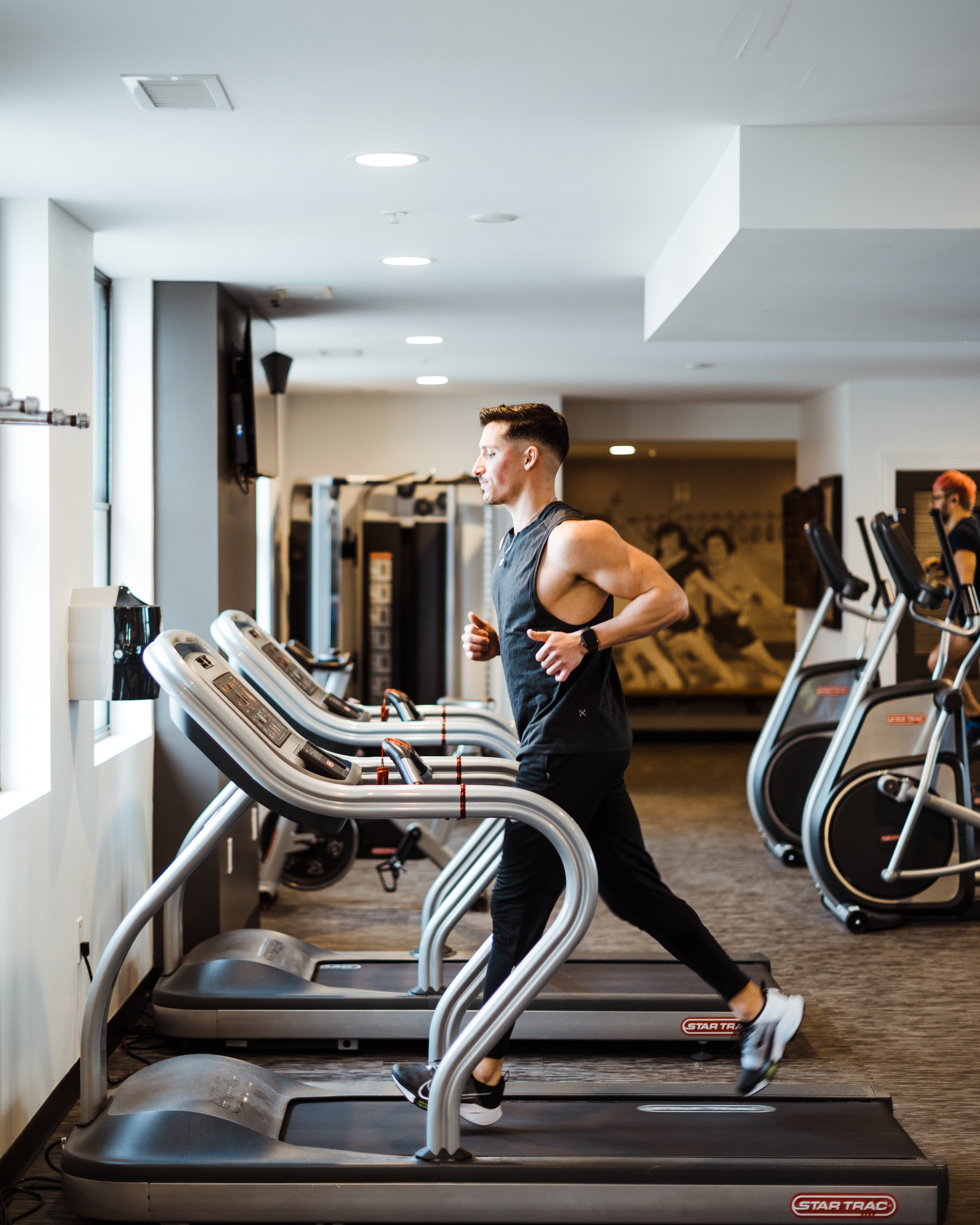 Resident in modern gym walking on treadmills at LeVeque Tower in Columbus, Ohio