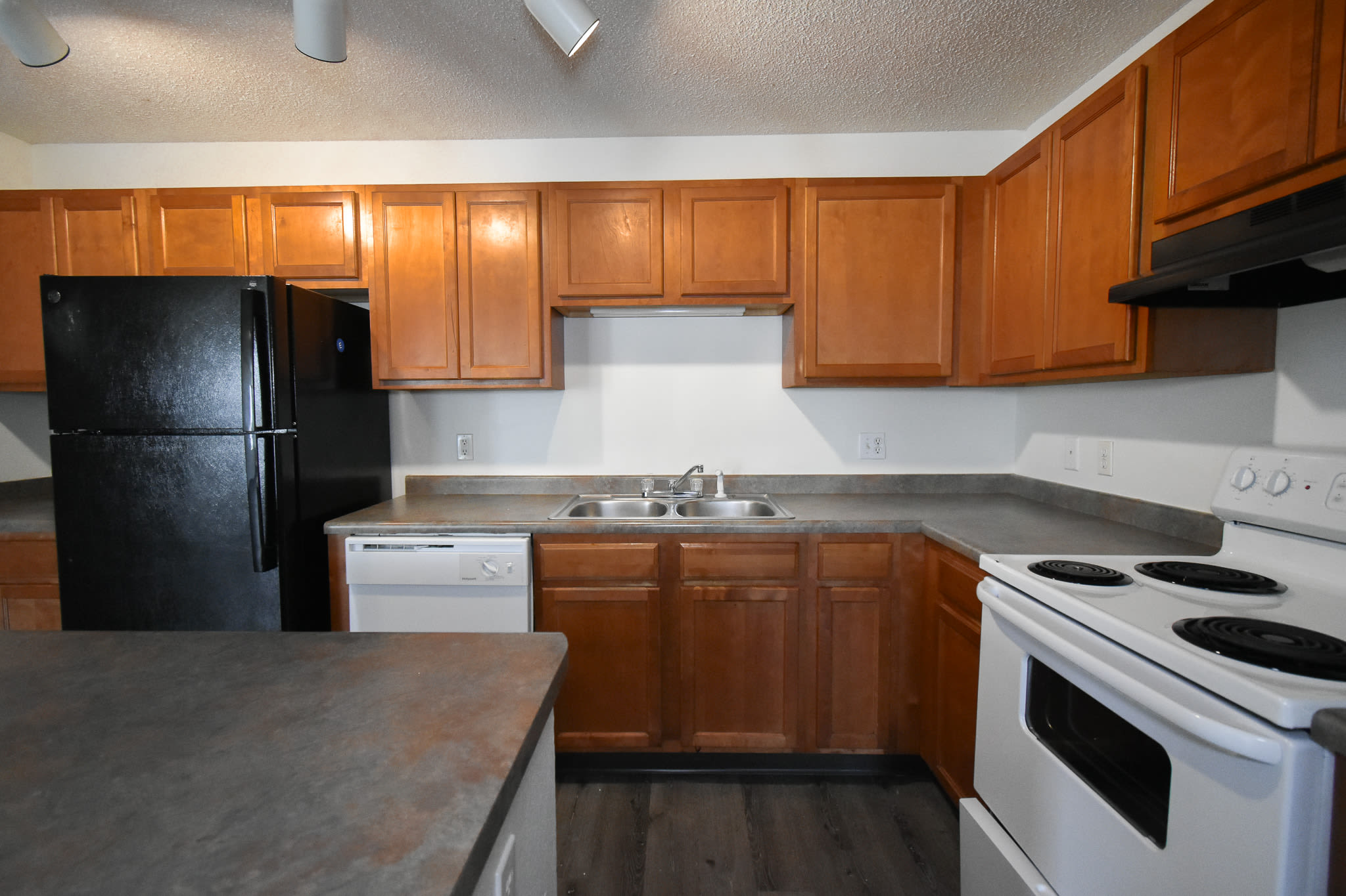 Fully-equipped kitchen with wood-style flooring and at River Run Apartments in Minneapolis, Minnesota