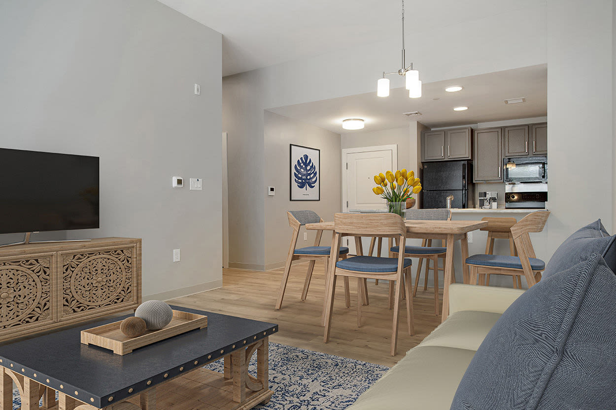 Living room with a couch and a dining area at Walker School Apartments in Taunton, Massachusetts