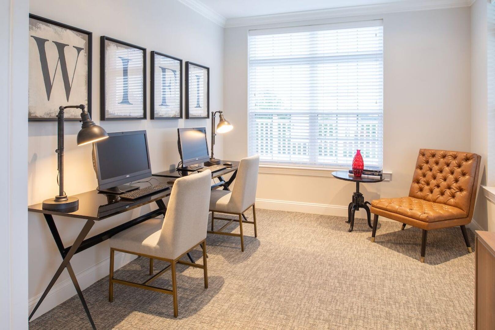 Business center with computers and comfortable seating for residents at The Elms at Germantown in Germantown, Maryland