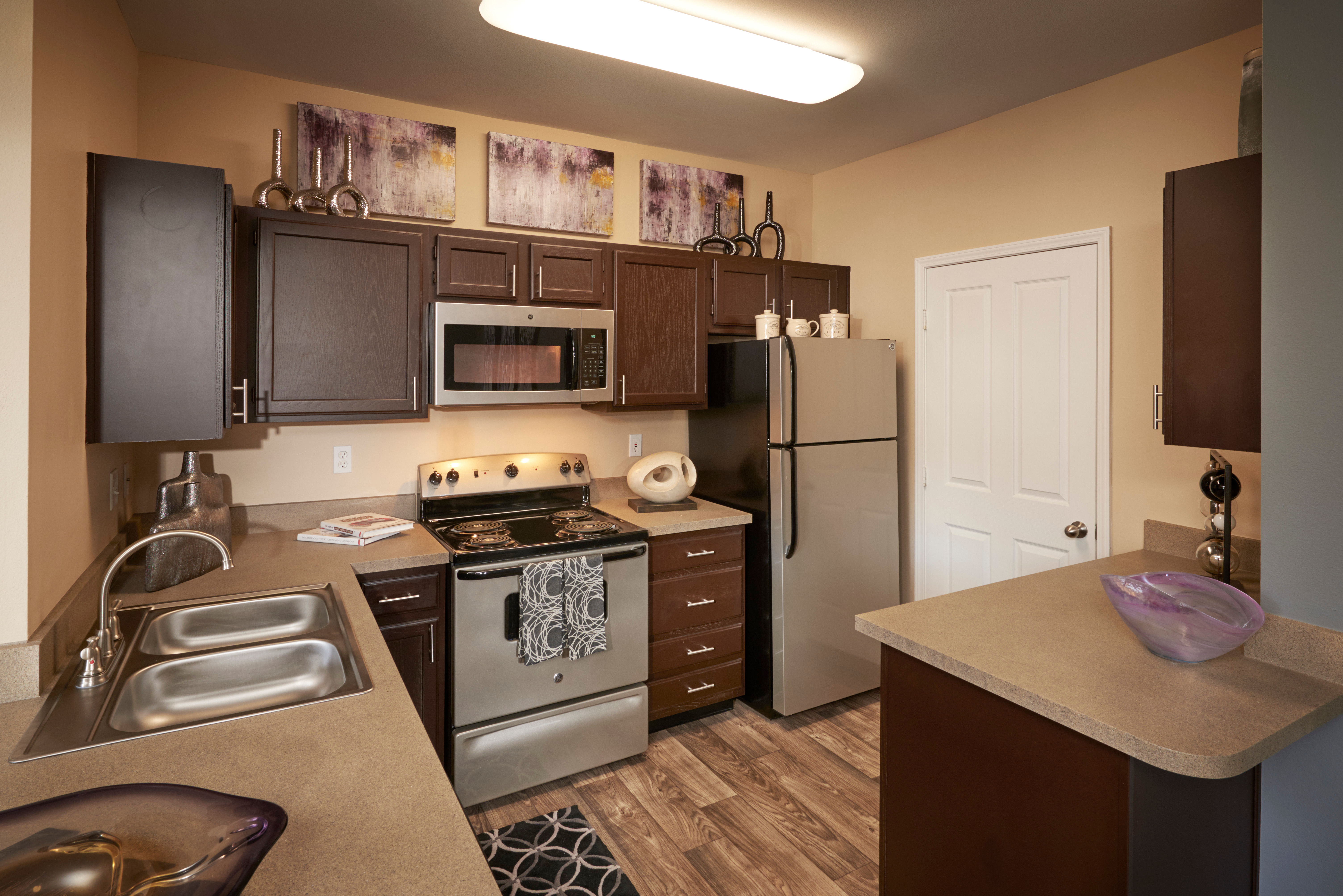 Kitchen with stainless-steel appliances at Legend Oaks Apartments in Aurora, Colorado