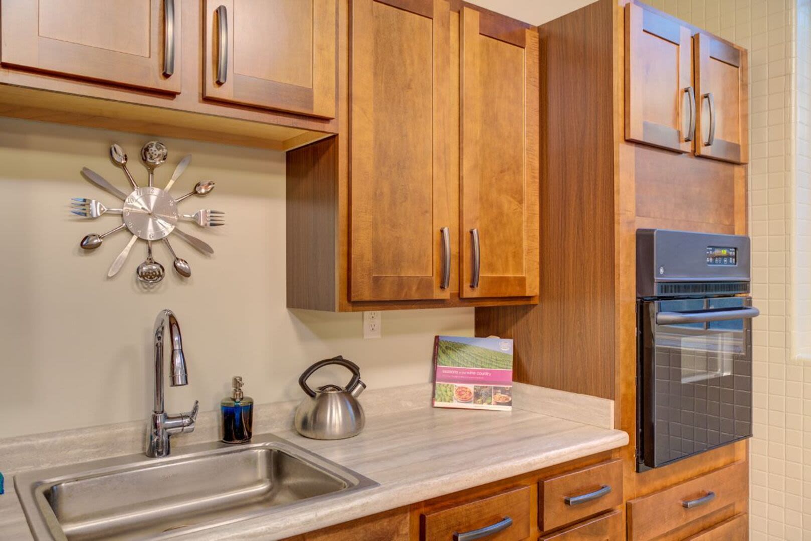 Kitchen with stainless steel sink and granite countertops at Bethany Apartments in Hanover, Massachusetts