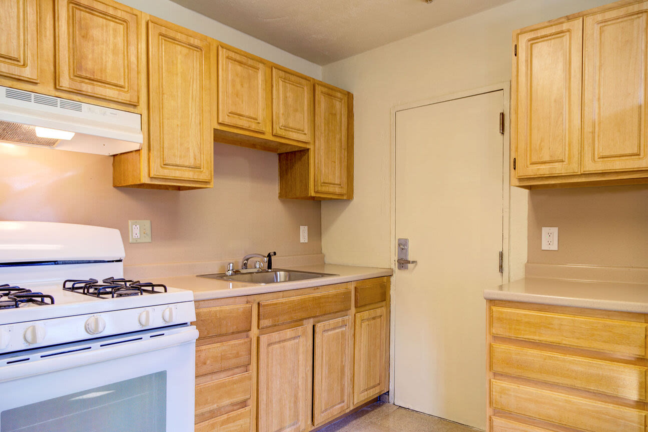 Modern kitchen with wooden cabinets at Blue Elm United Estates in Dorchester, Massachusetts