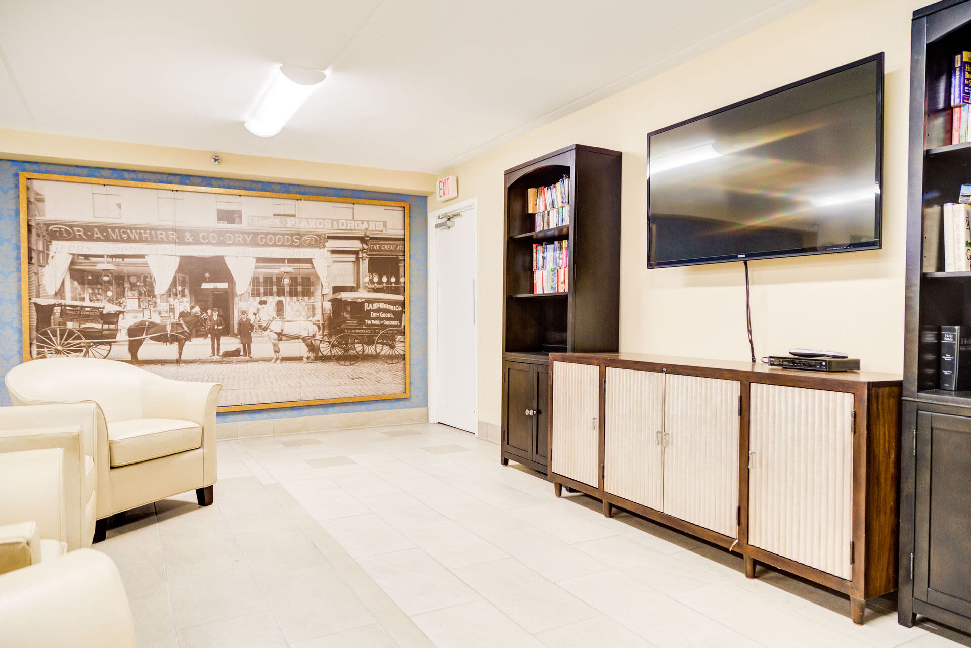 Community lounge with couches and a TV at Borden Place Apartments in Fall River, Massachusetts