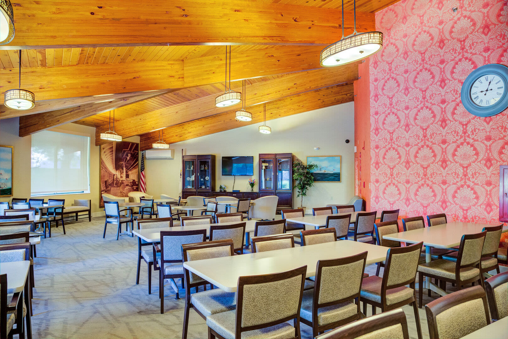 Community gathering space with chairs and tables at Borden Place Apartments in Fall River, Massachusetts