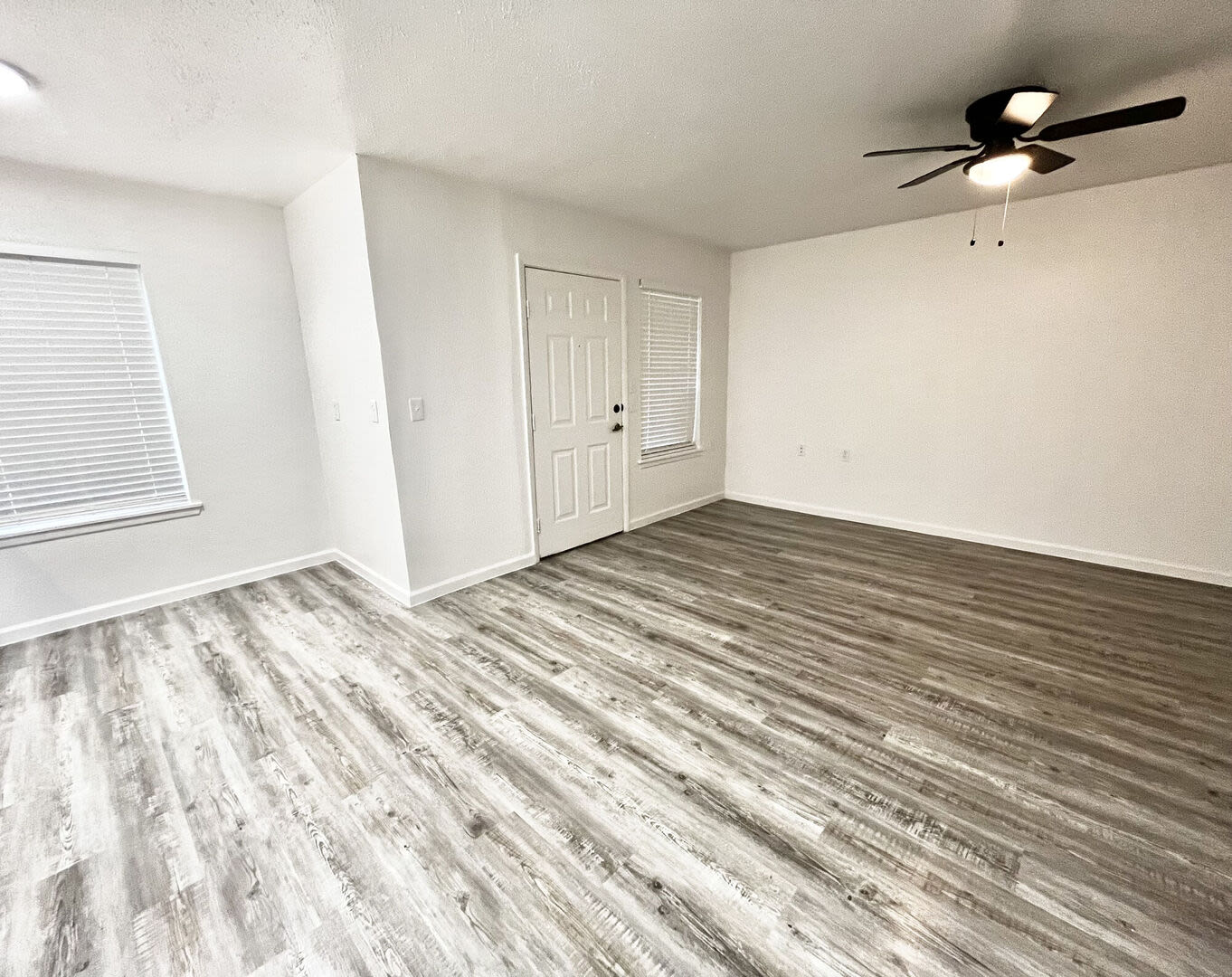 Bright living room with window at Grapeland Apartments in Grapeland, Texas