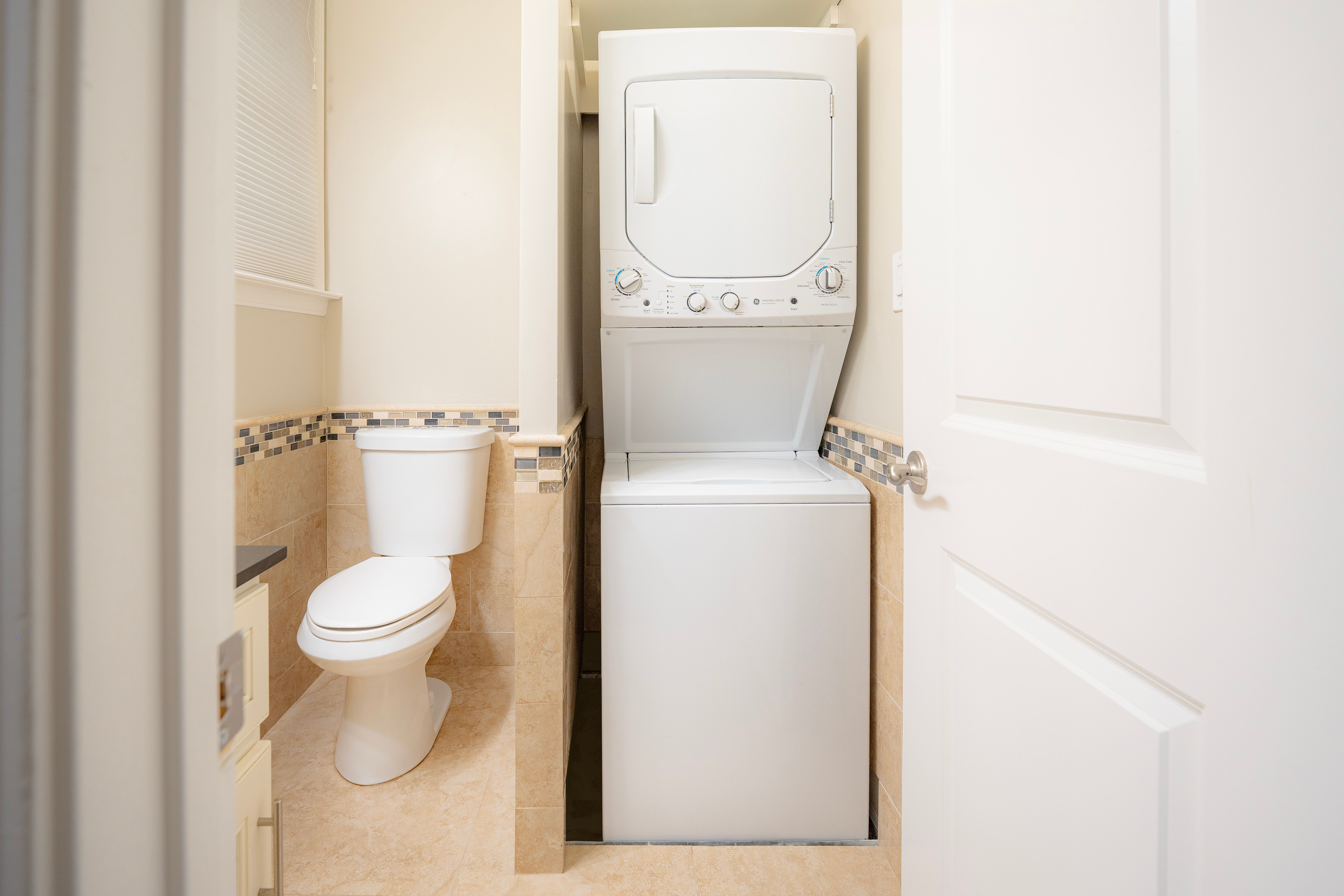 Small bathroom with stacked washer and dryer