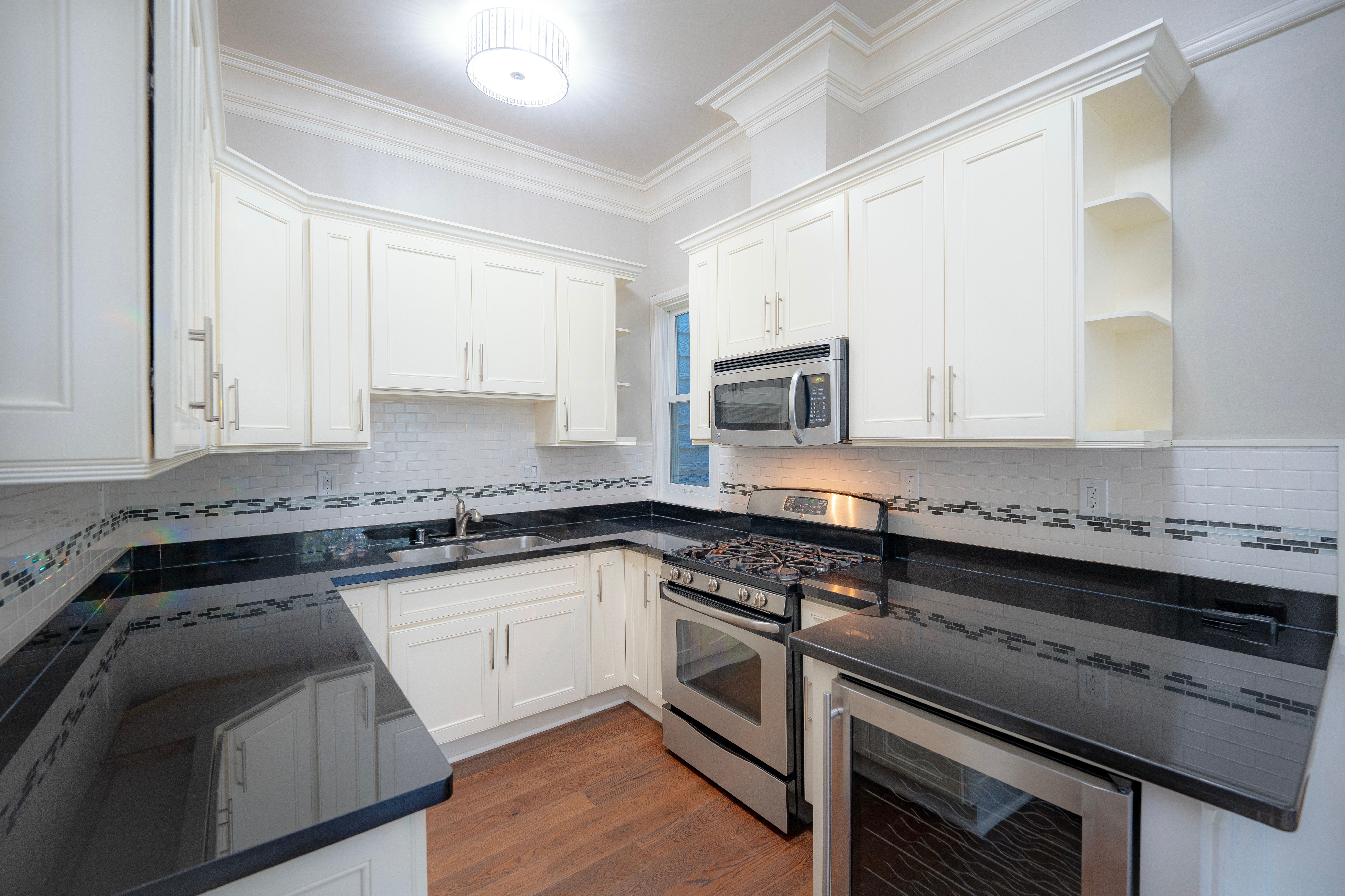 Modern kitchen with white cabinets and stainless steel appliances