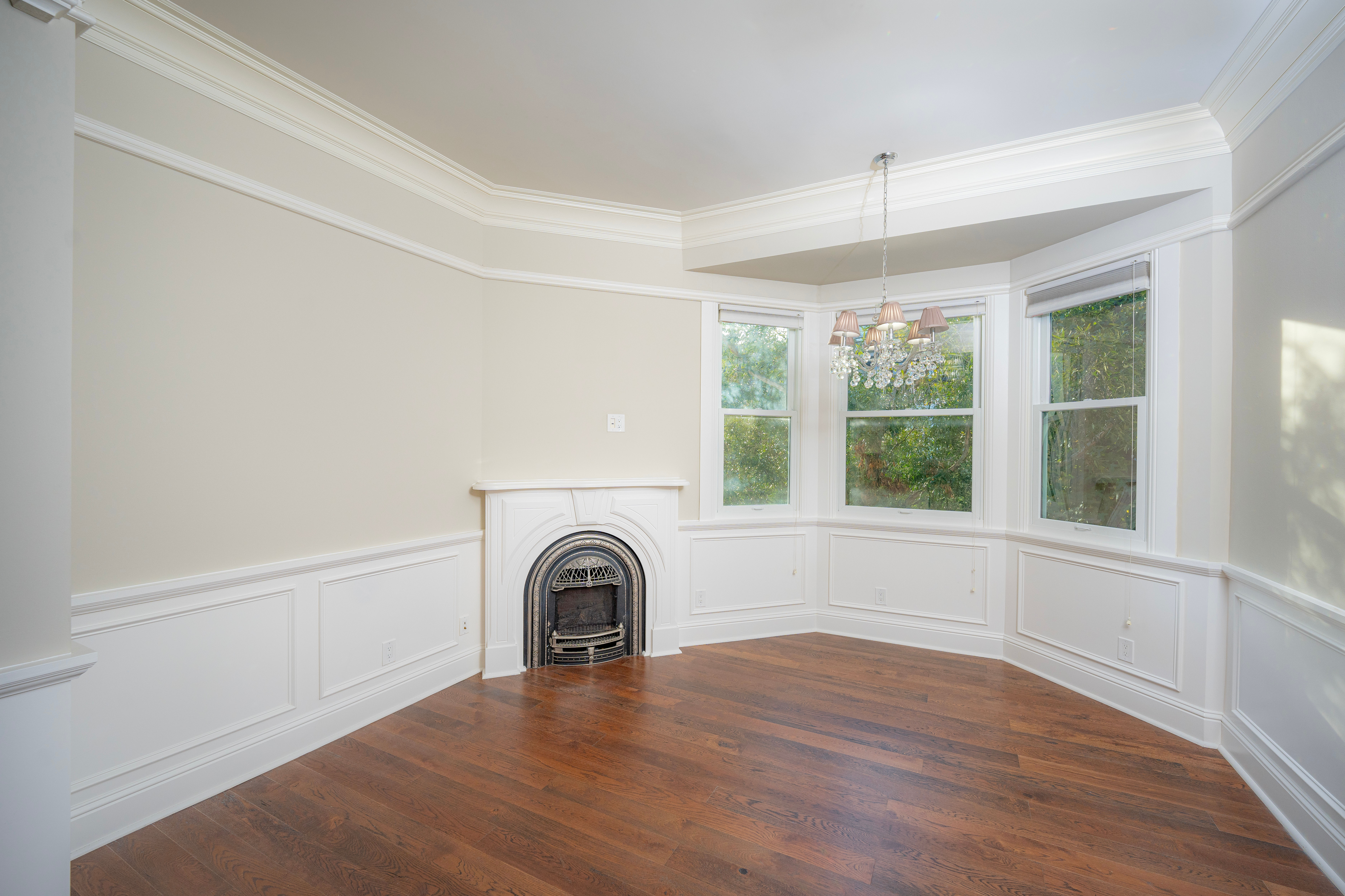 Empty room with fireplace and large windows