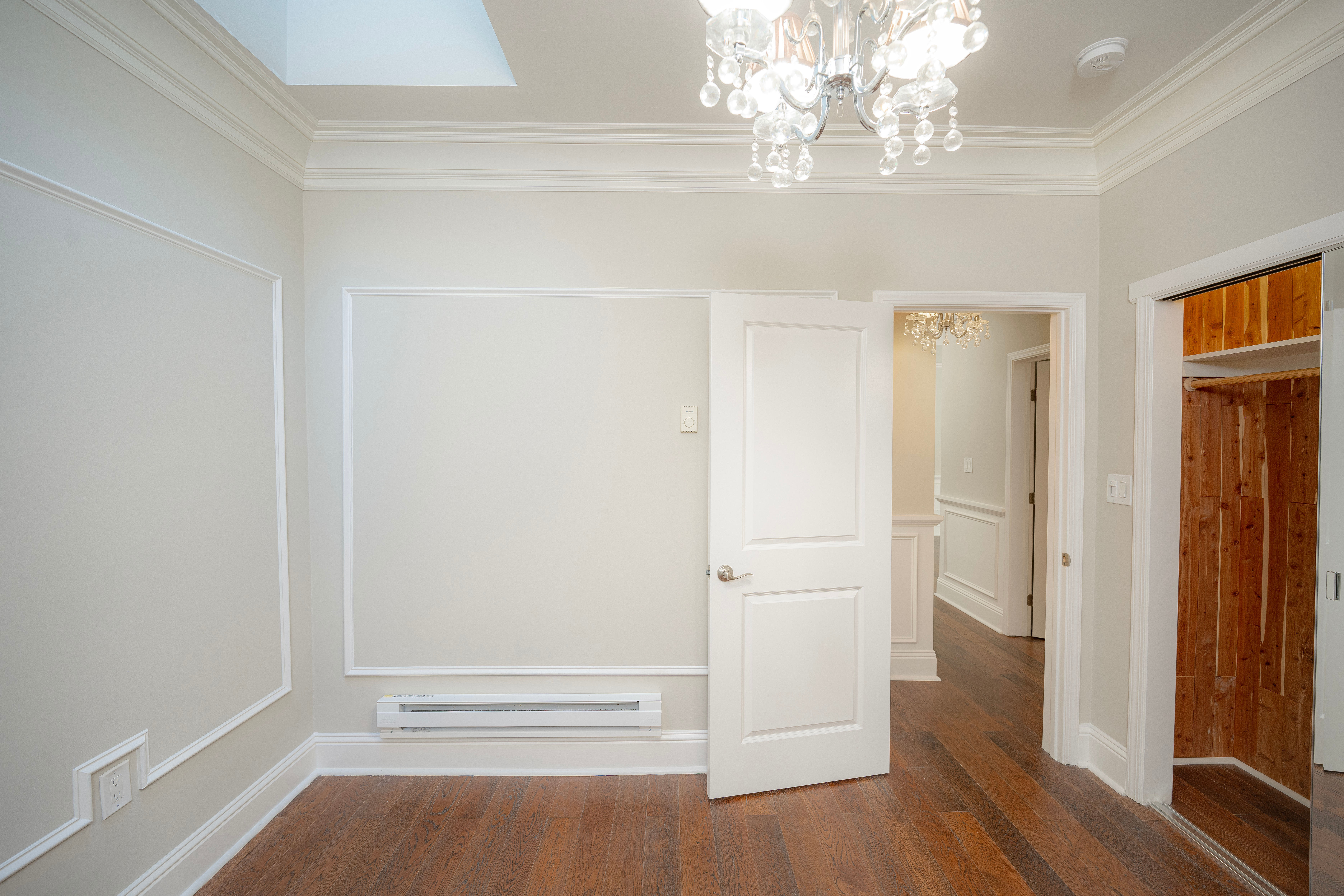 Empty room with wooden floor and chandelier
