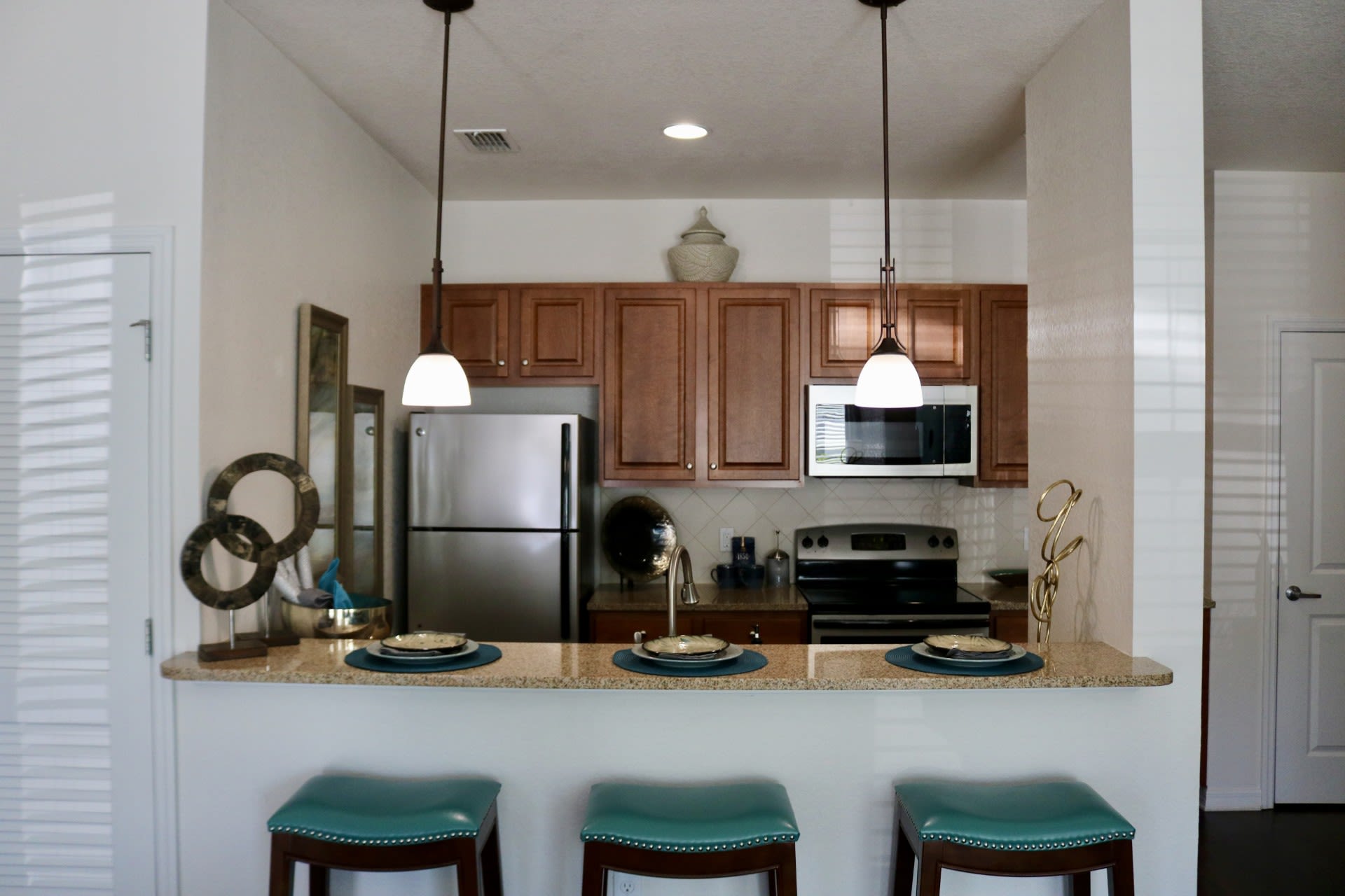 Apartment kitchen with breakfast bar at Goldelm at Bennett Park in Bradenton, Florida