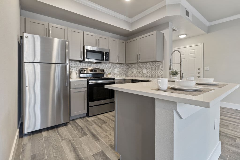 Stainless-steel refrigerator and breakfast counter in the kitchen at Charleston in San Antonio,Texas