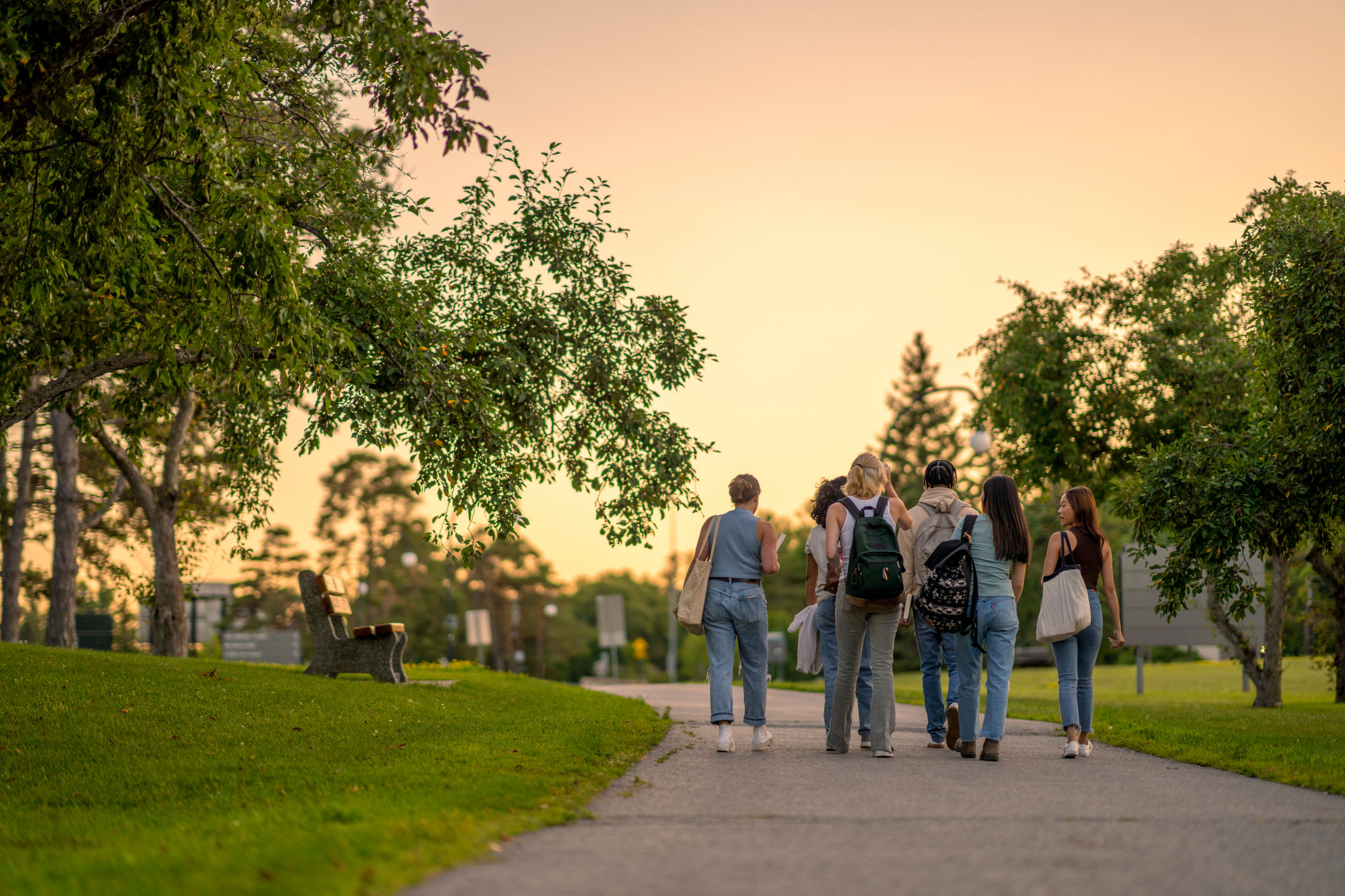 Resident friends walking in a park near RIVA Solana Beach in Solana Beach, California